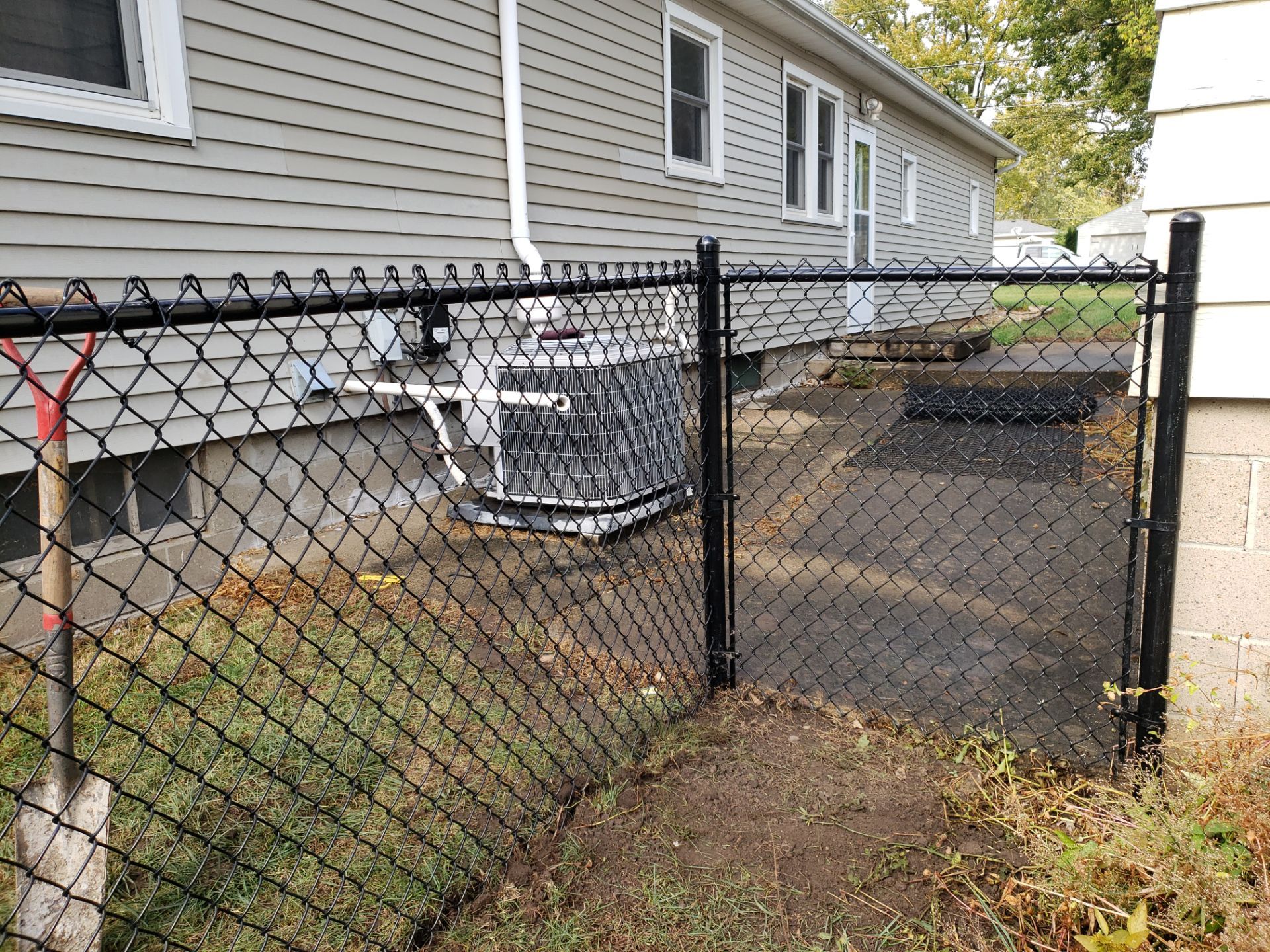 Residential Black Vinyl-Coated Chain Link Fence in Waterloo by Perfect Picket Fence and Stain