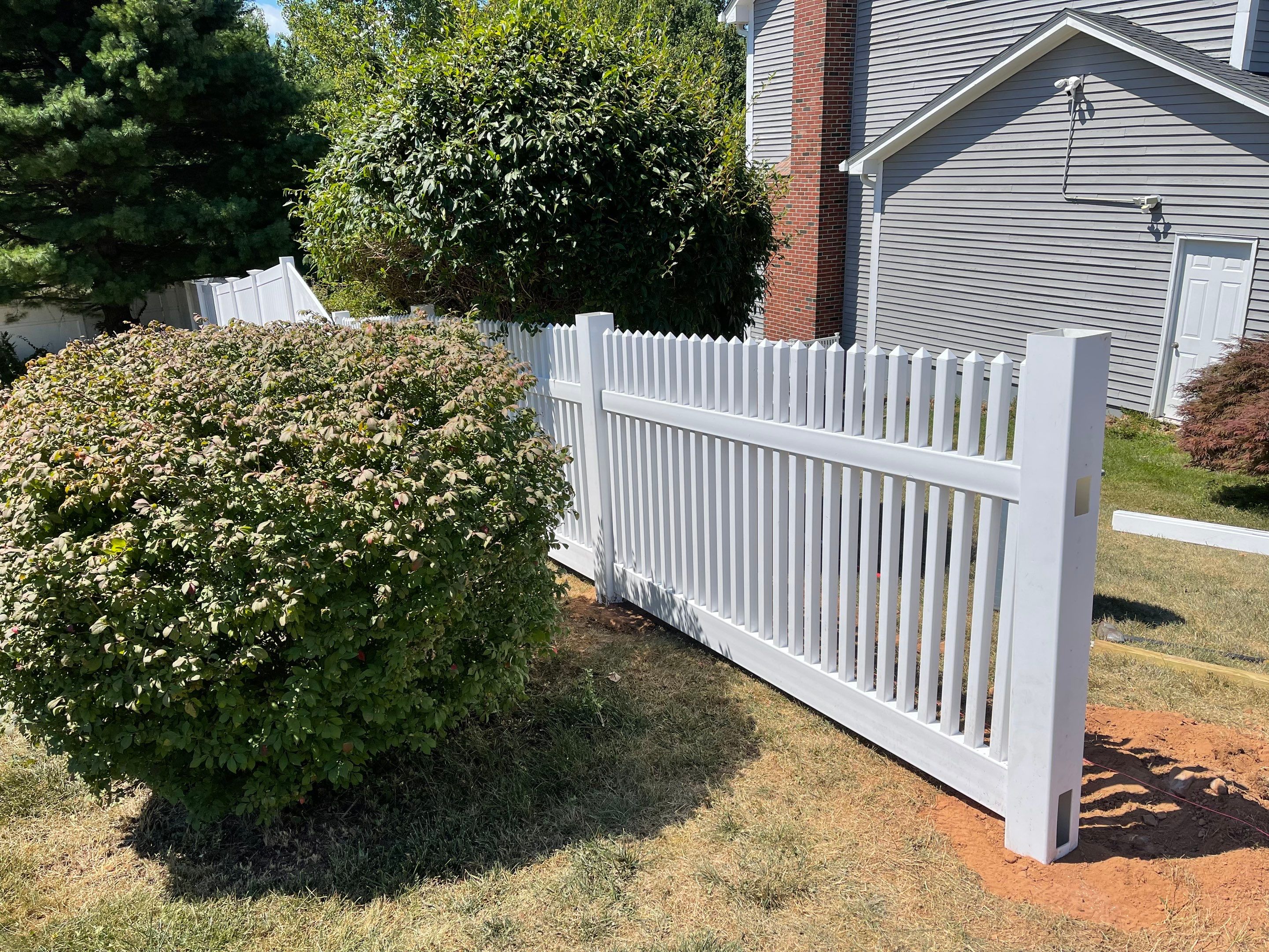New Vinyl privacy fence and picket fence in white by DiGiorgi Roofing and Siding Inc