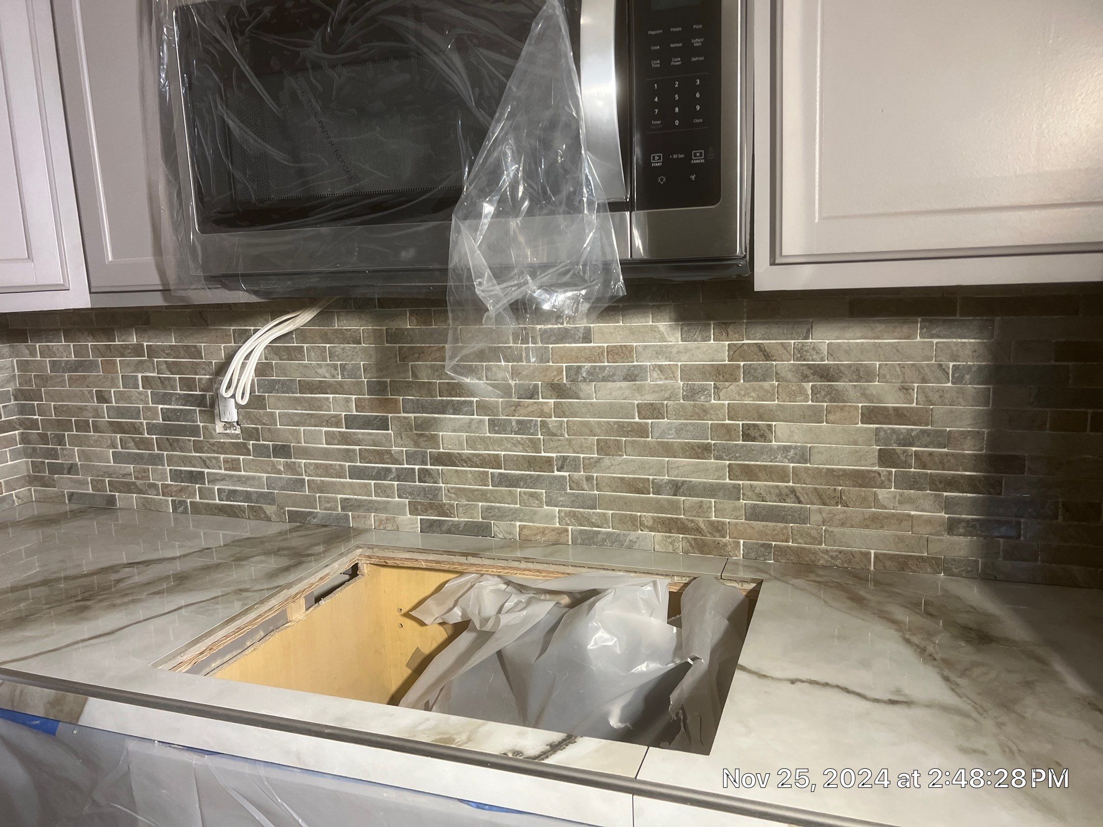 Marble Look Countertop and Stone Tile Backsplash Installation in Brookings by KMD Surfaces INC.