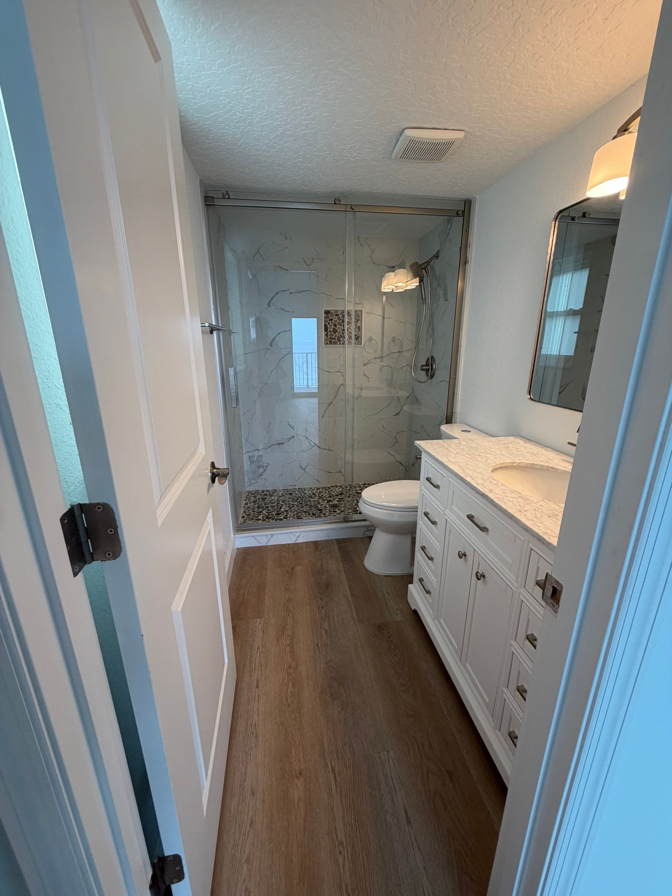 Full Condominium Remodel Featuring Aubrey Oak Flooring In Daytona Beach by Acies Renovations