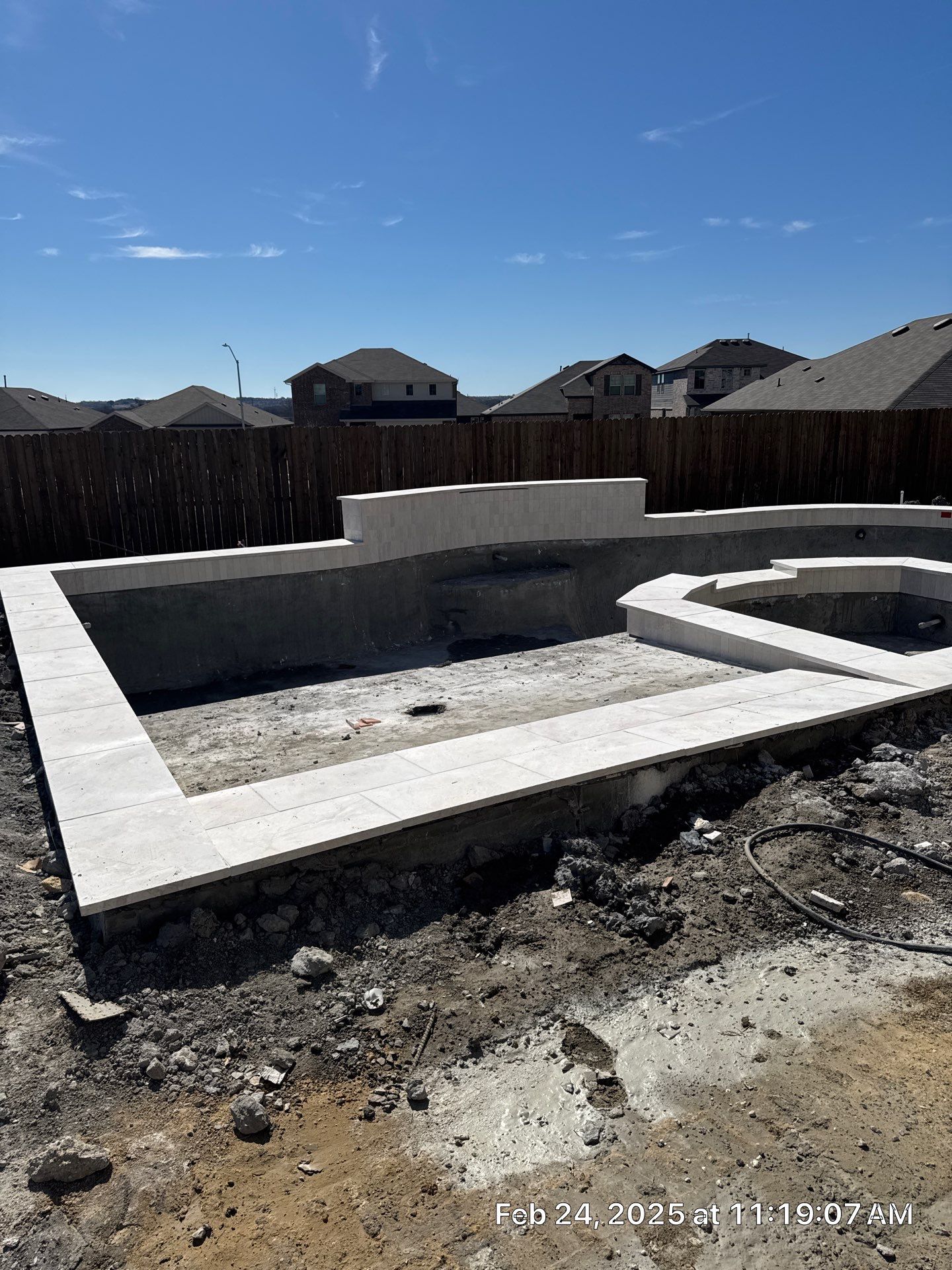 Geometric Pool with Spillover Spa and Dark Interior by Pinnacle Pools and Spas - DFW