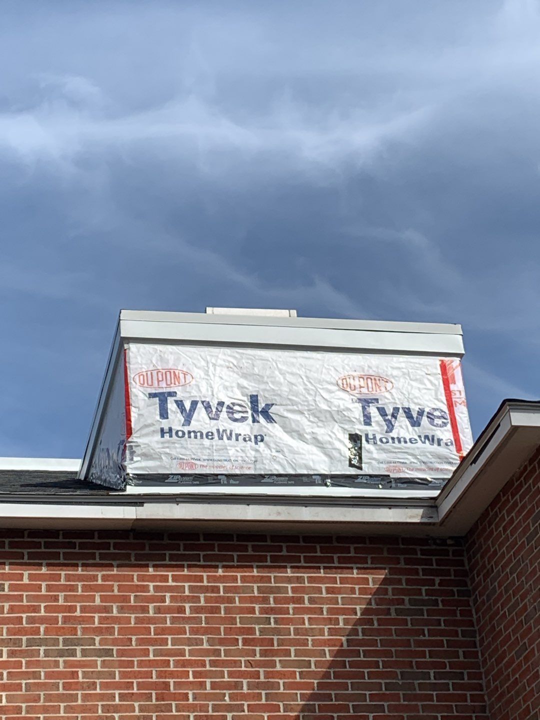 Commercial Roofing Installation using EPDM with white gutters by A Plus Exterior