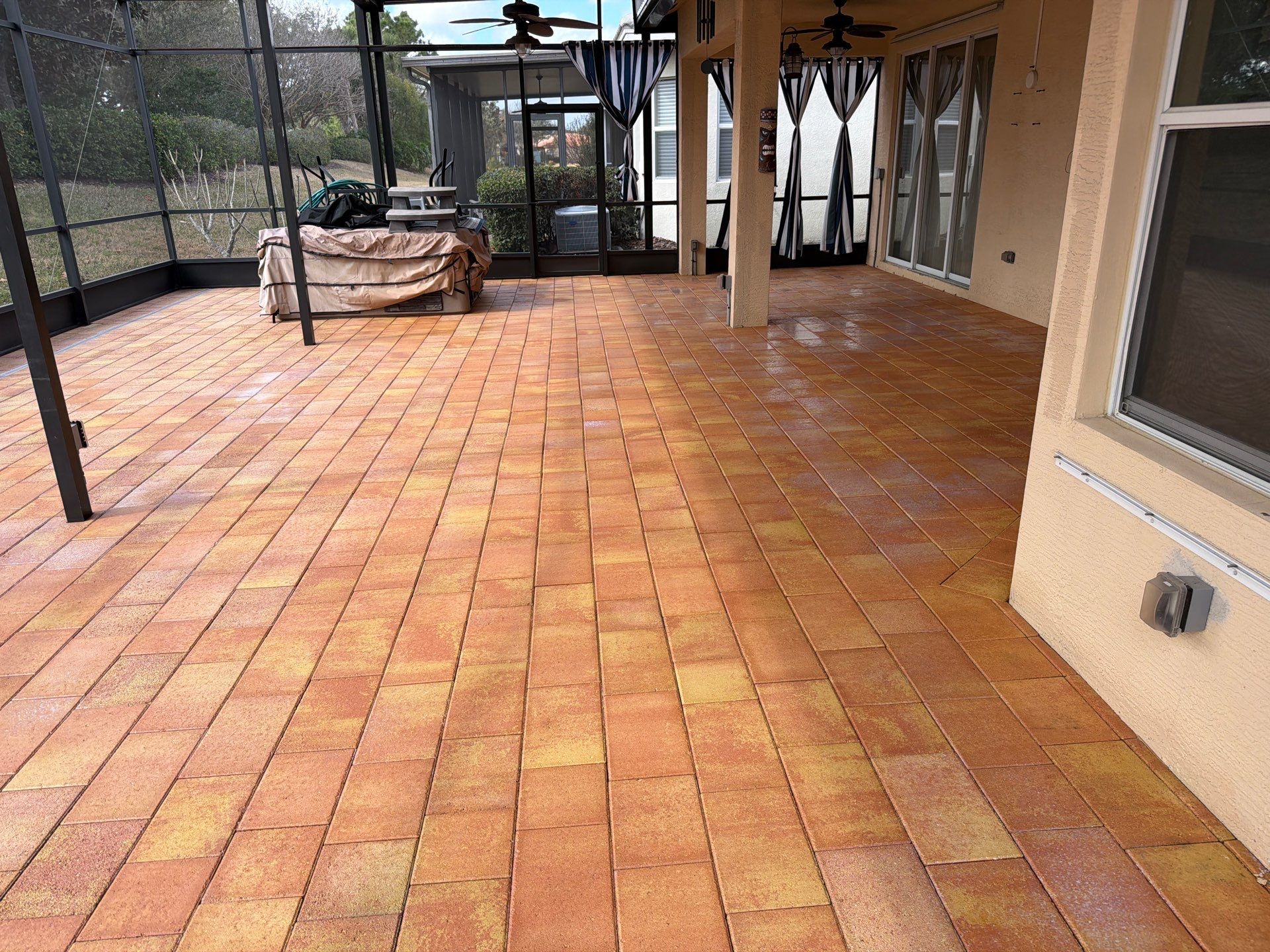 Paver Sealing for Herringbone Driveway and Screened Lanai in Valencia Lakes by Supreme Paver Experts
