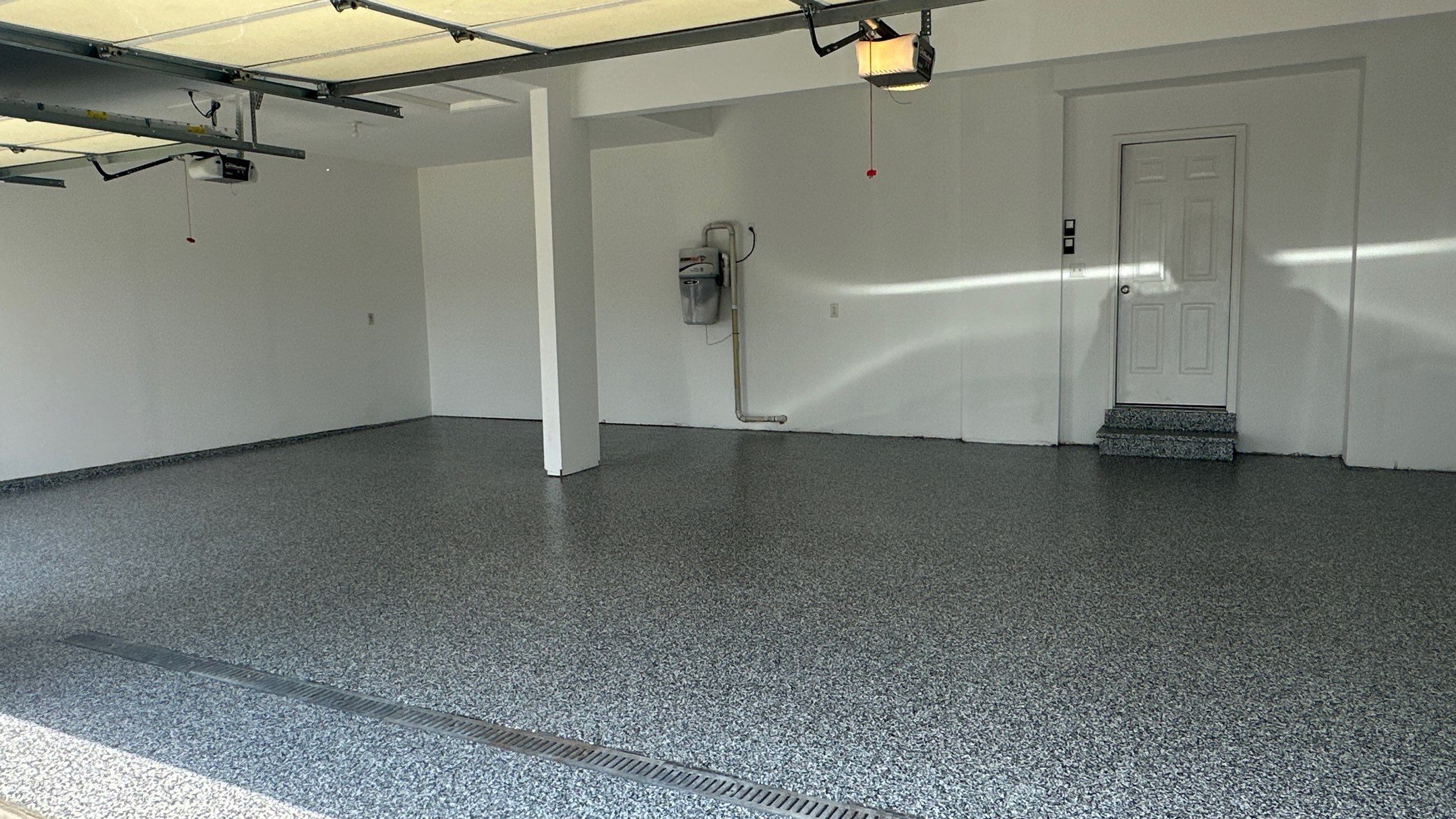 Laura B. garage transformation with a new floor and garage storage  by Banner Garage