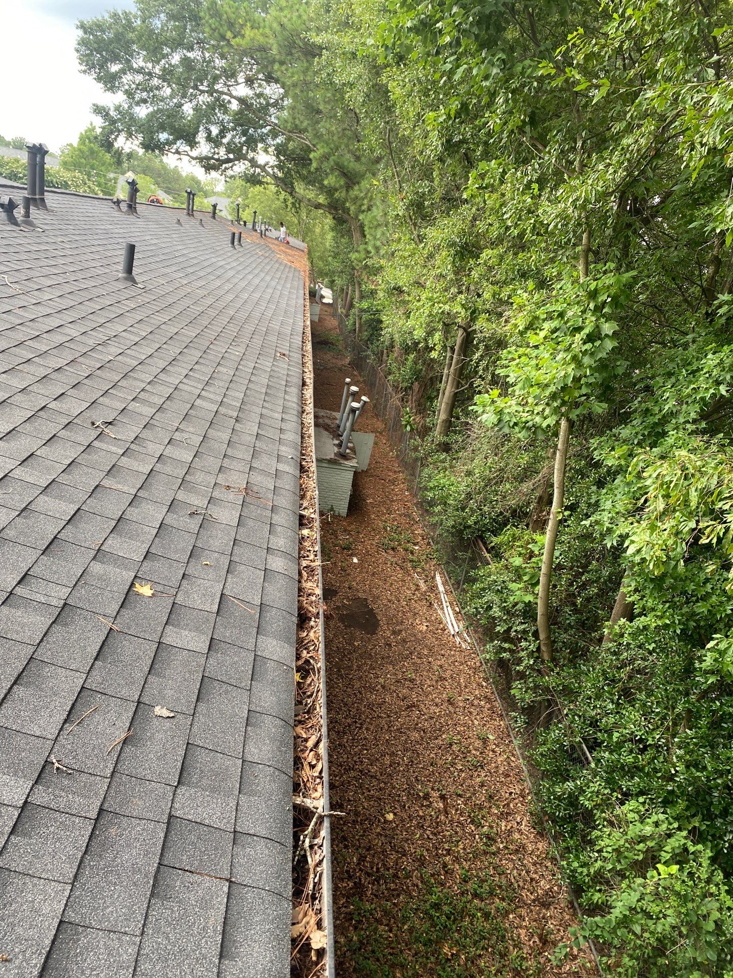 Commercial gutter cleaning Atlanta before photo with filled gutters