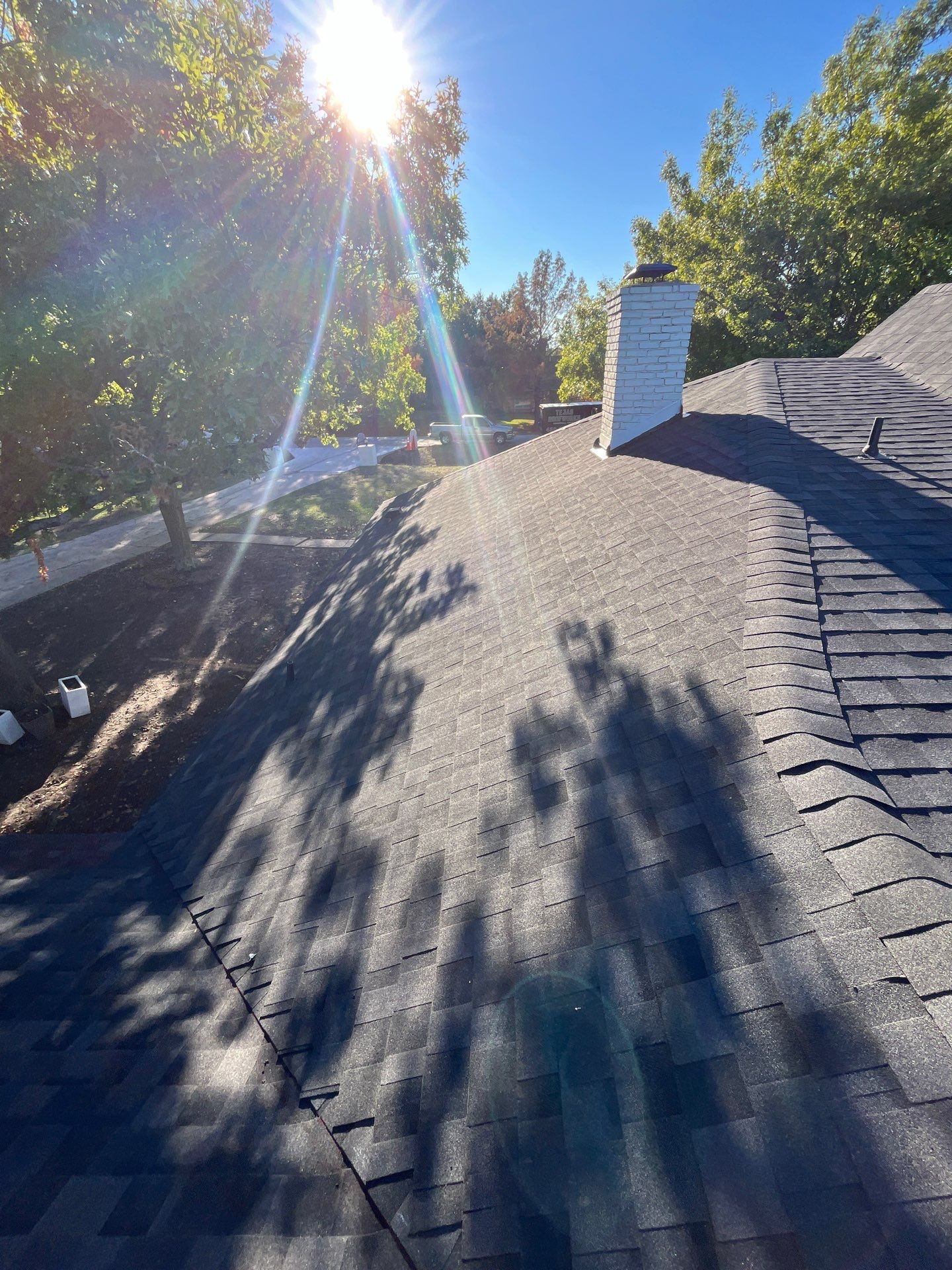 White brick with IKO Granite Black by Tejas Roofworks + Restoration