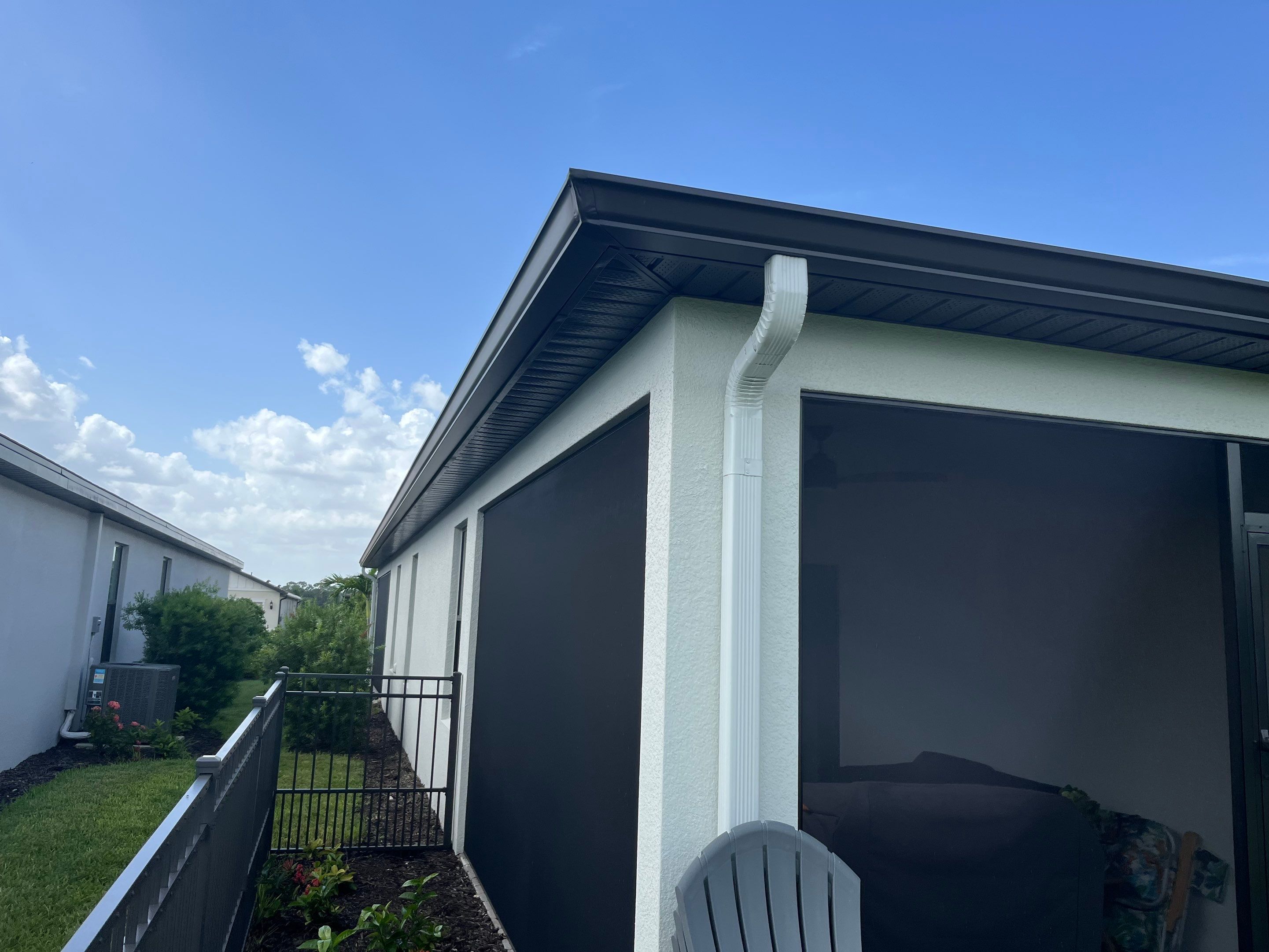 Dark Bronze Gutters and White Downspouts in Sarasota FL by Gutter Professors