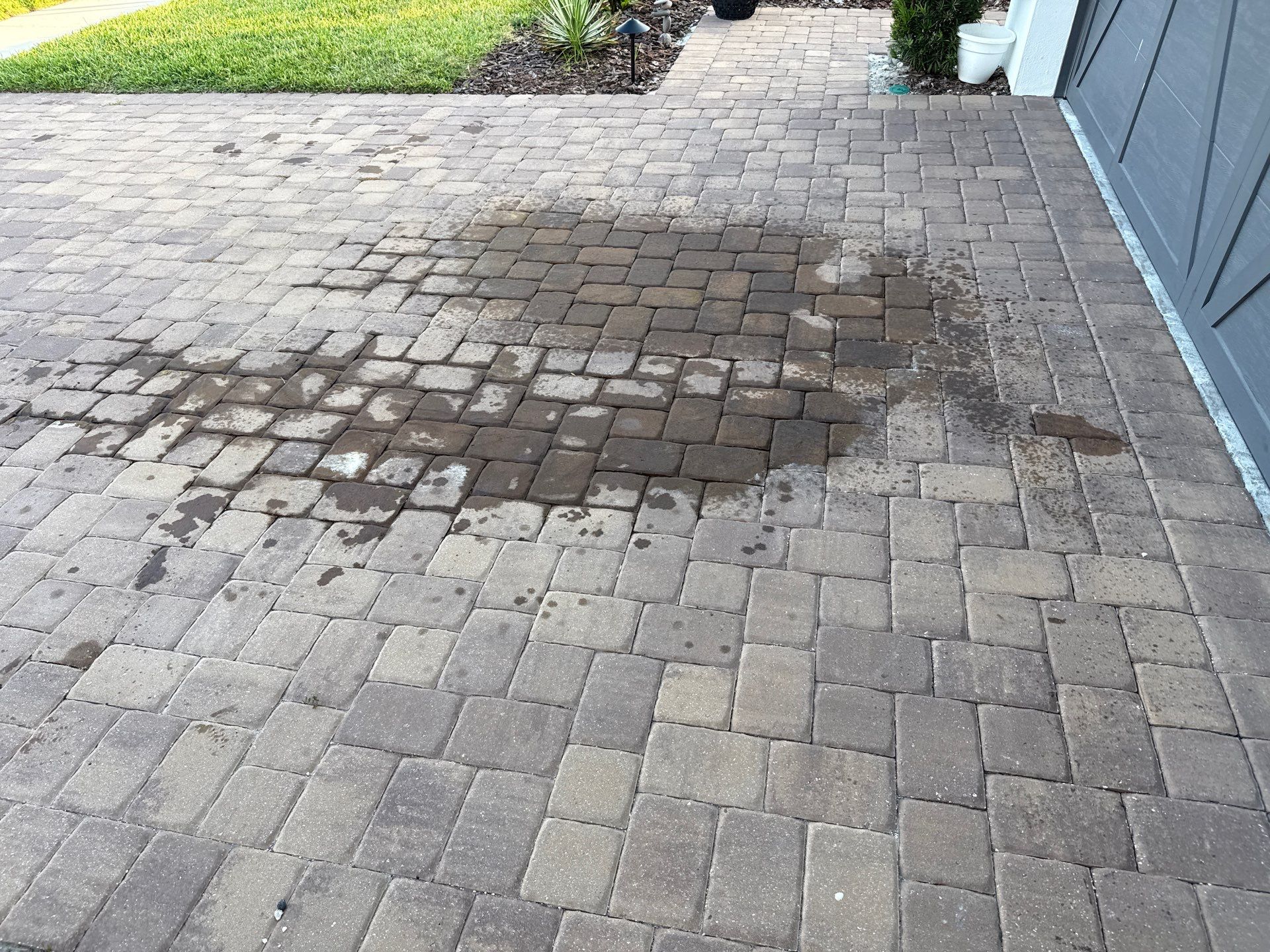 Oil Stain Removal on Paver Driveway | Esplanade at Artisan Lakes, Palmetto FL by Sunshine AquaWash