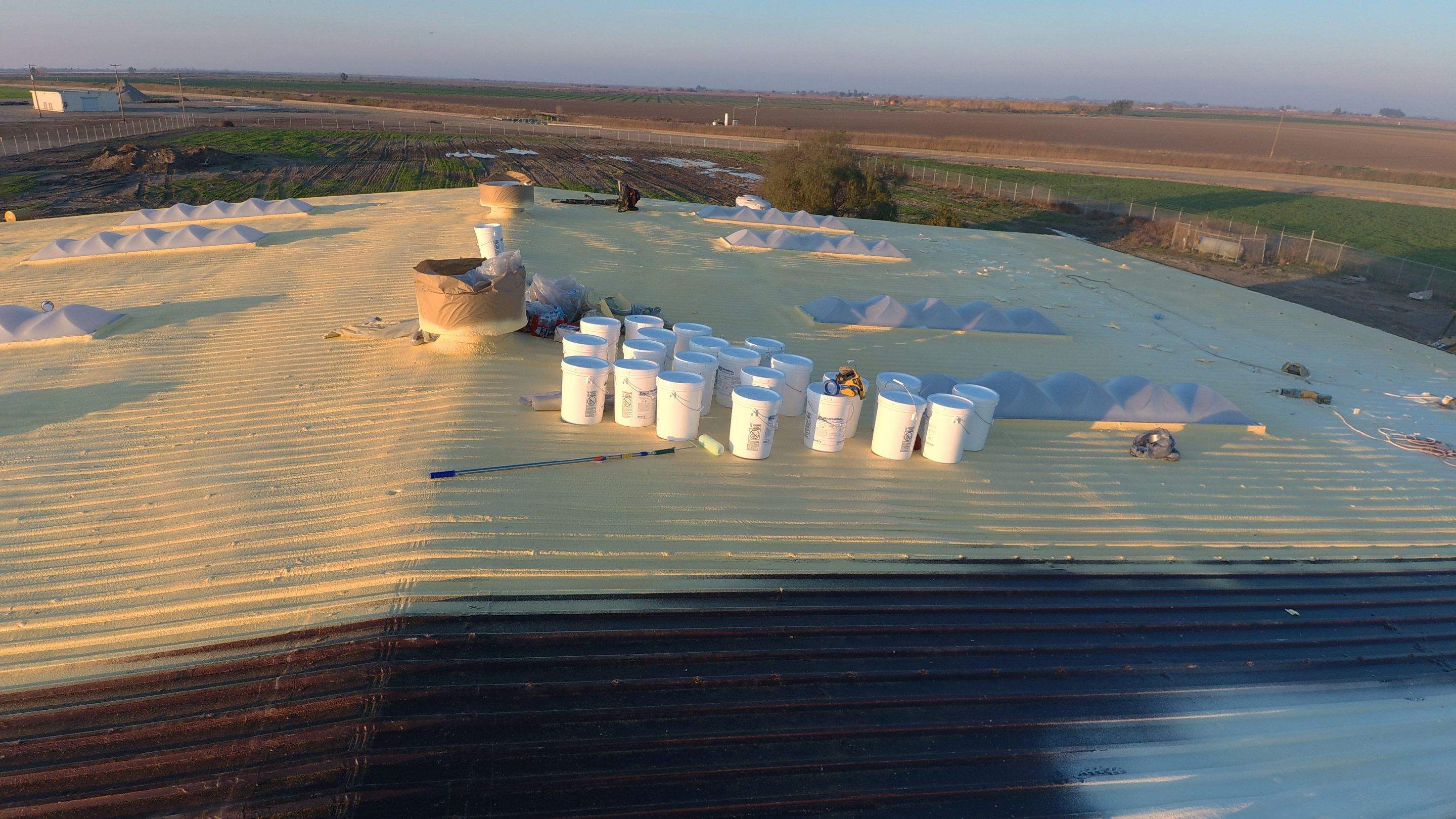 Metal roof restoration on commercial roof using Conklin Benchmark/ PUMA XL acrylic coatings over metal and foam by Straight Edge Roofing Inc