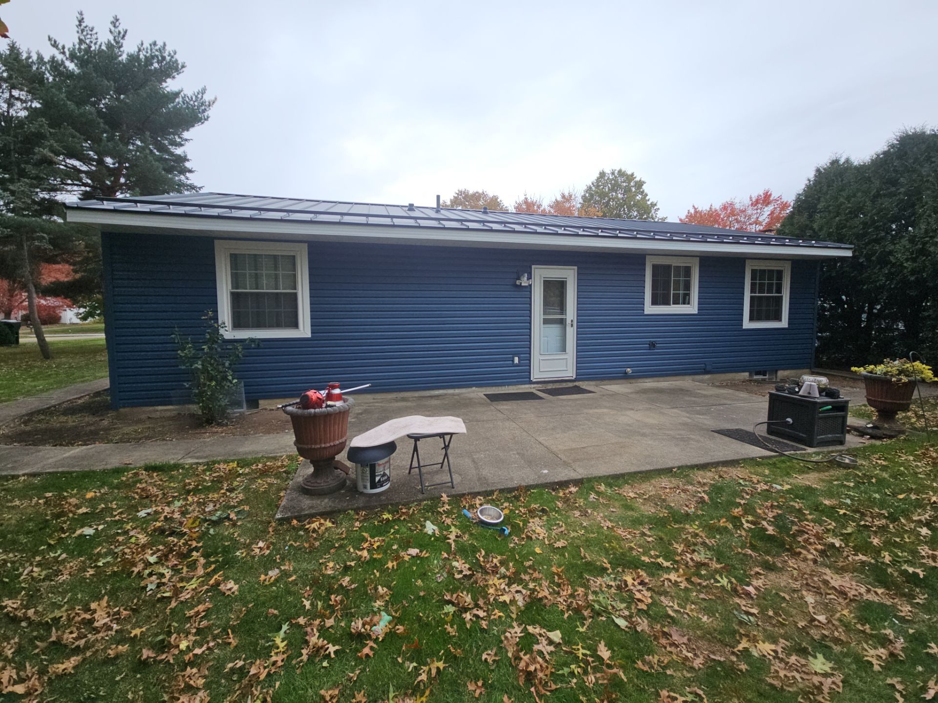 Wadsworth Exterior Transformation Featuring Blue Vertical Siding and Metal Roofing by Cornerstone Roofing And Siding