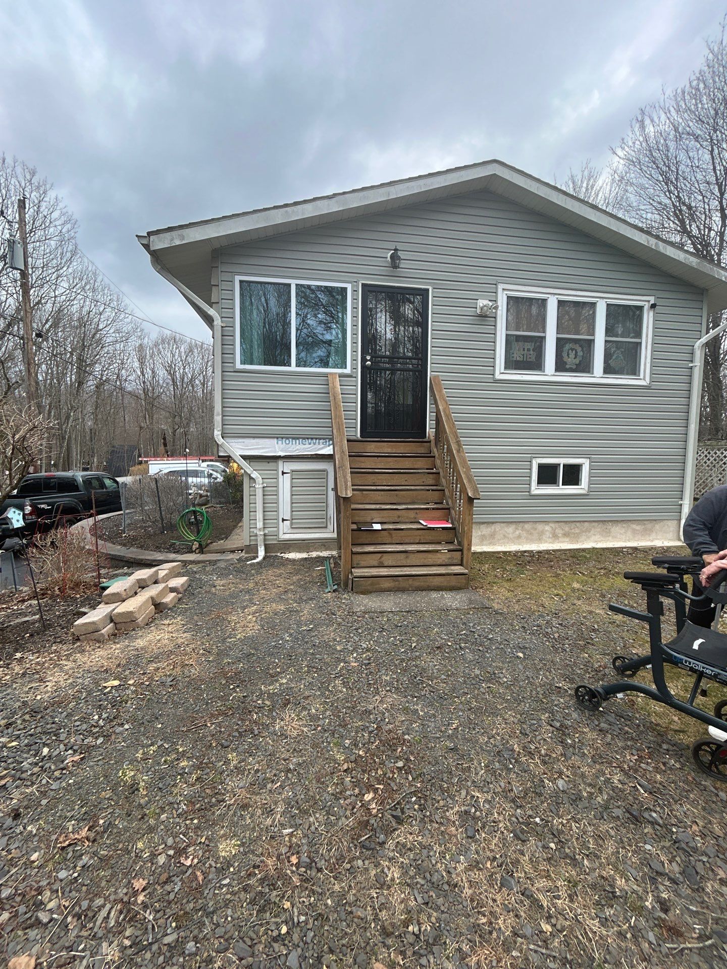 Raised Gray Composite Deck and Staircase Construction in Pocono Summit, PA by Herts Roofing & Construction