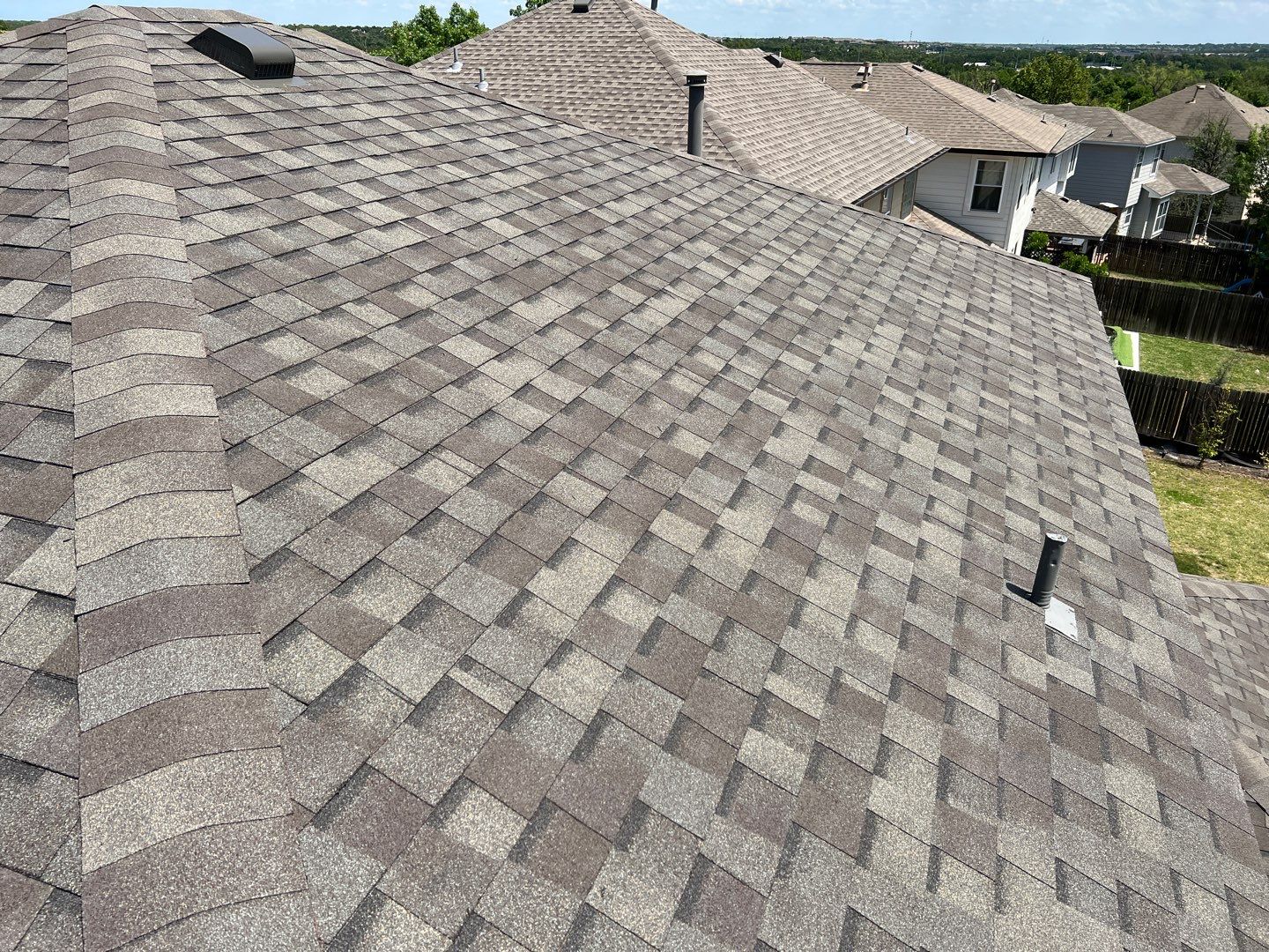 Wind damaged roof replacement by Oakwood Roofing and Construction, LLC