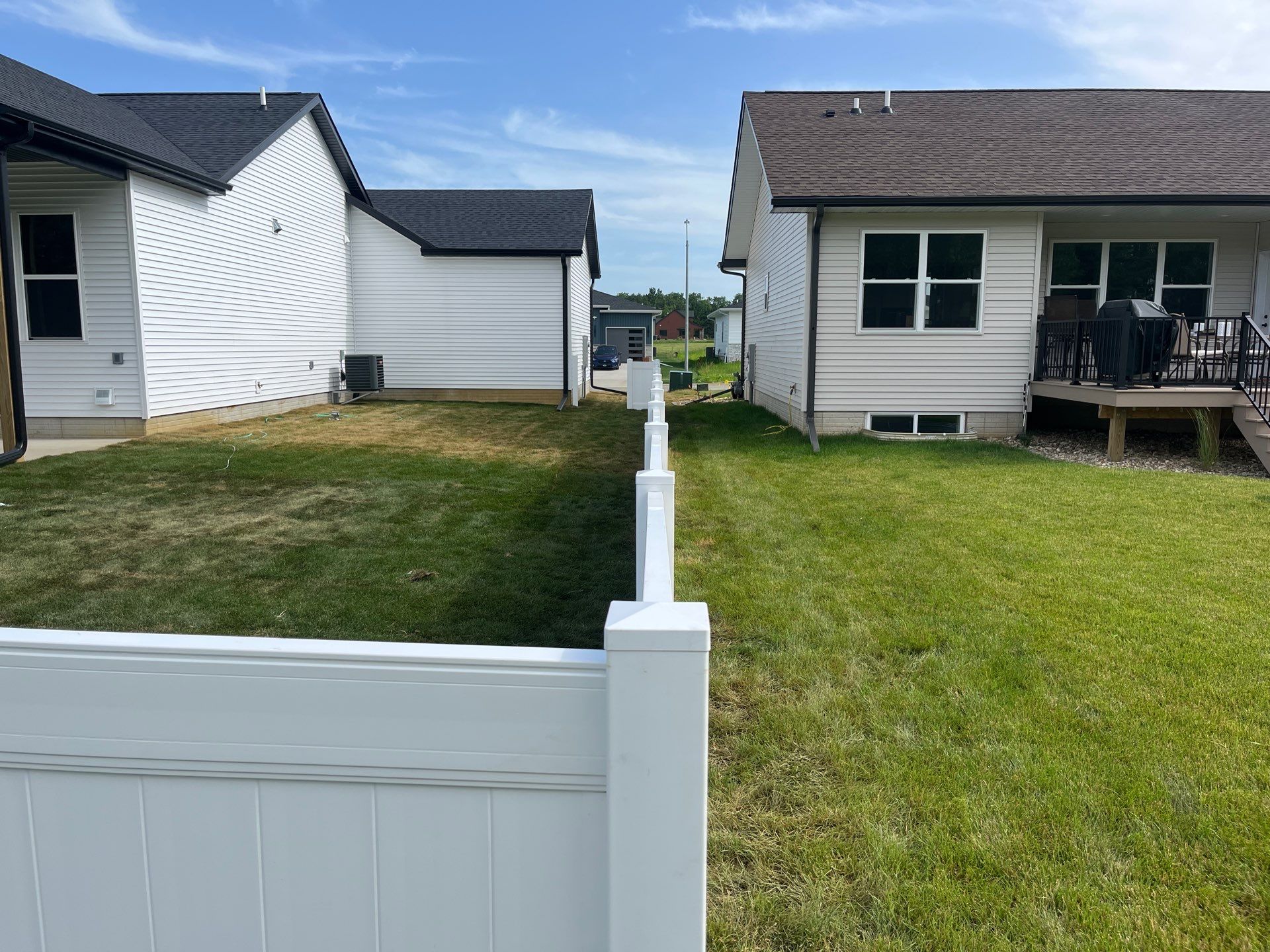 White Vinyl Privacy Fence With Pet Window in Cedar Falls by Perfect Picket Fence and Stain