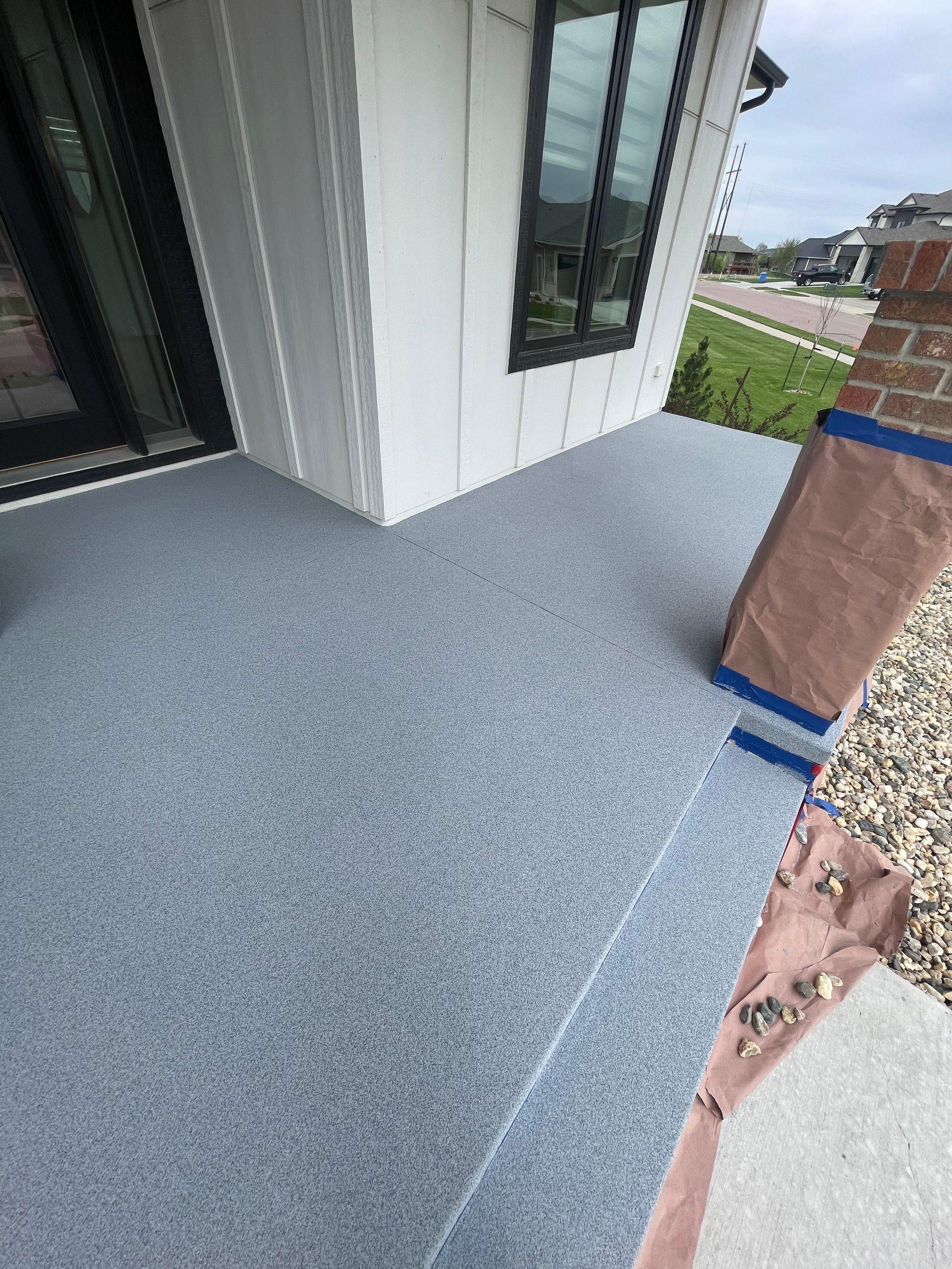 Grey Speckled Concrete Porch Coating for Sioux Falls Home by Select Painting, Coatings & Garage Cabinets