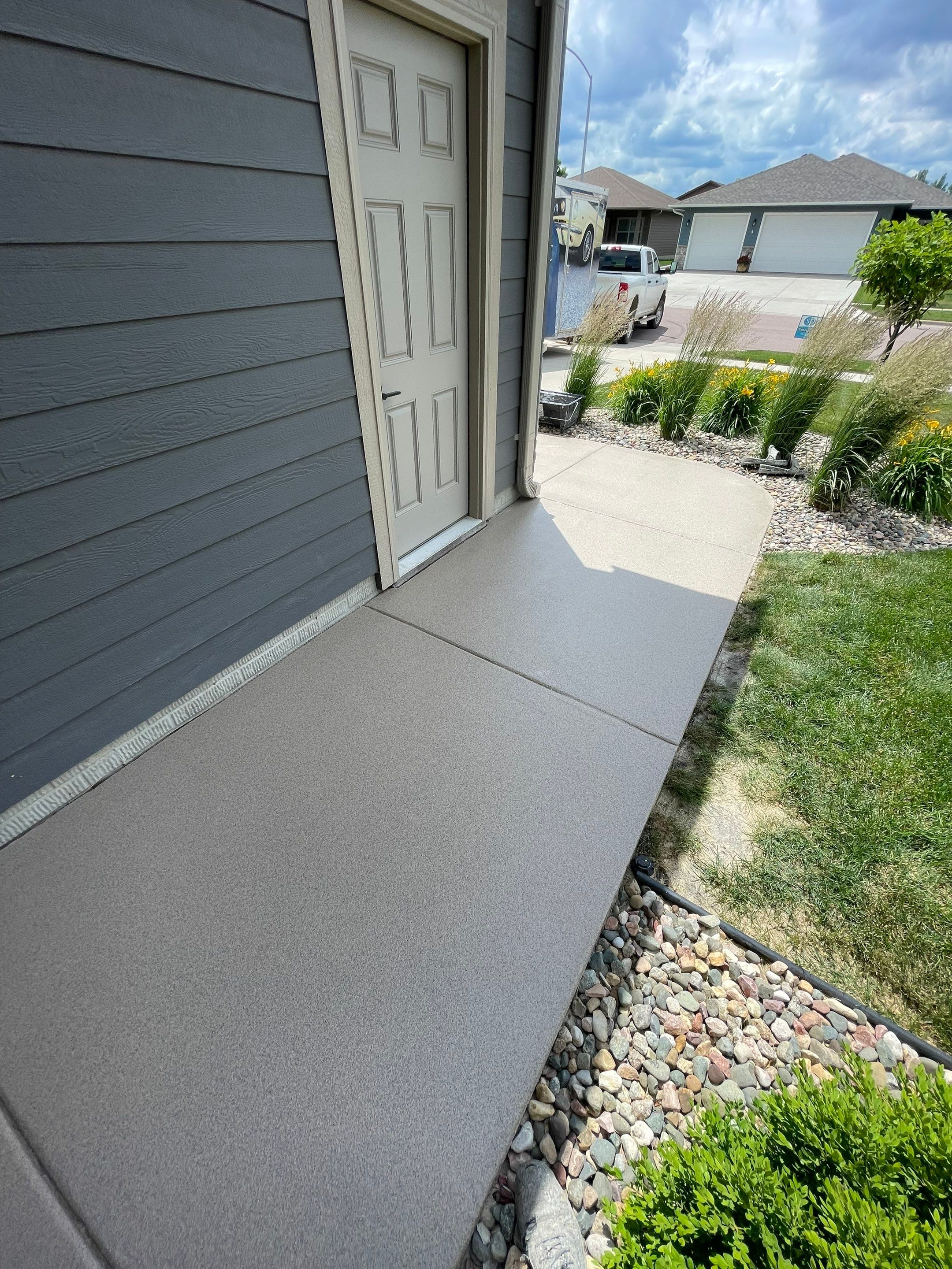 Textured Concrete Patio Coating and Custom Privacy Pergola in Sioux Falls by Select Painting, Coatings & Garage Cabinets