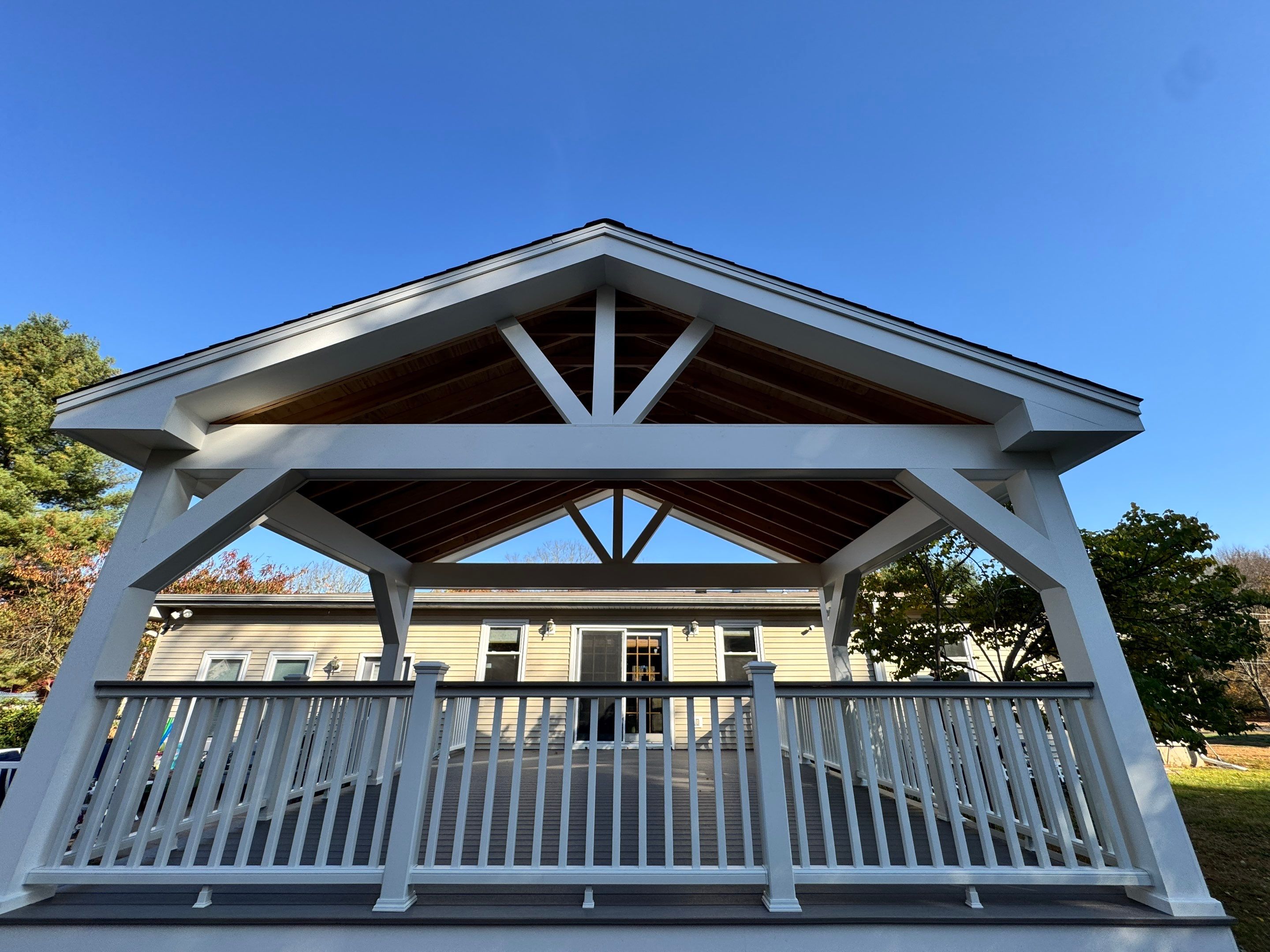 Replacement deck and Roof overhang. Trex Lineage Biscayne boards and matching cocktail rail.  by DiGiorgi Roofing and Siding Inc