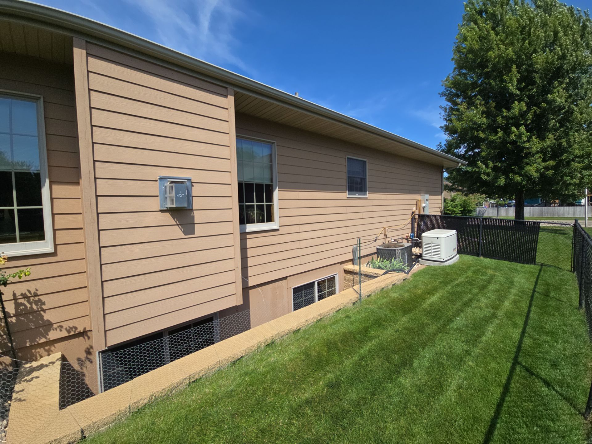 Sioux Falls Residential Exterior Door and Siding Refresh by Select Painting, Coatings & Garage Cabinets