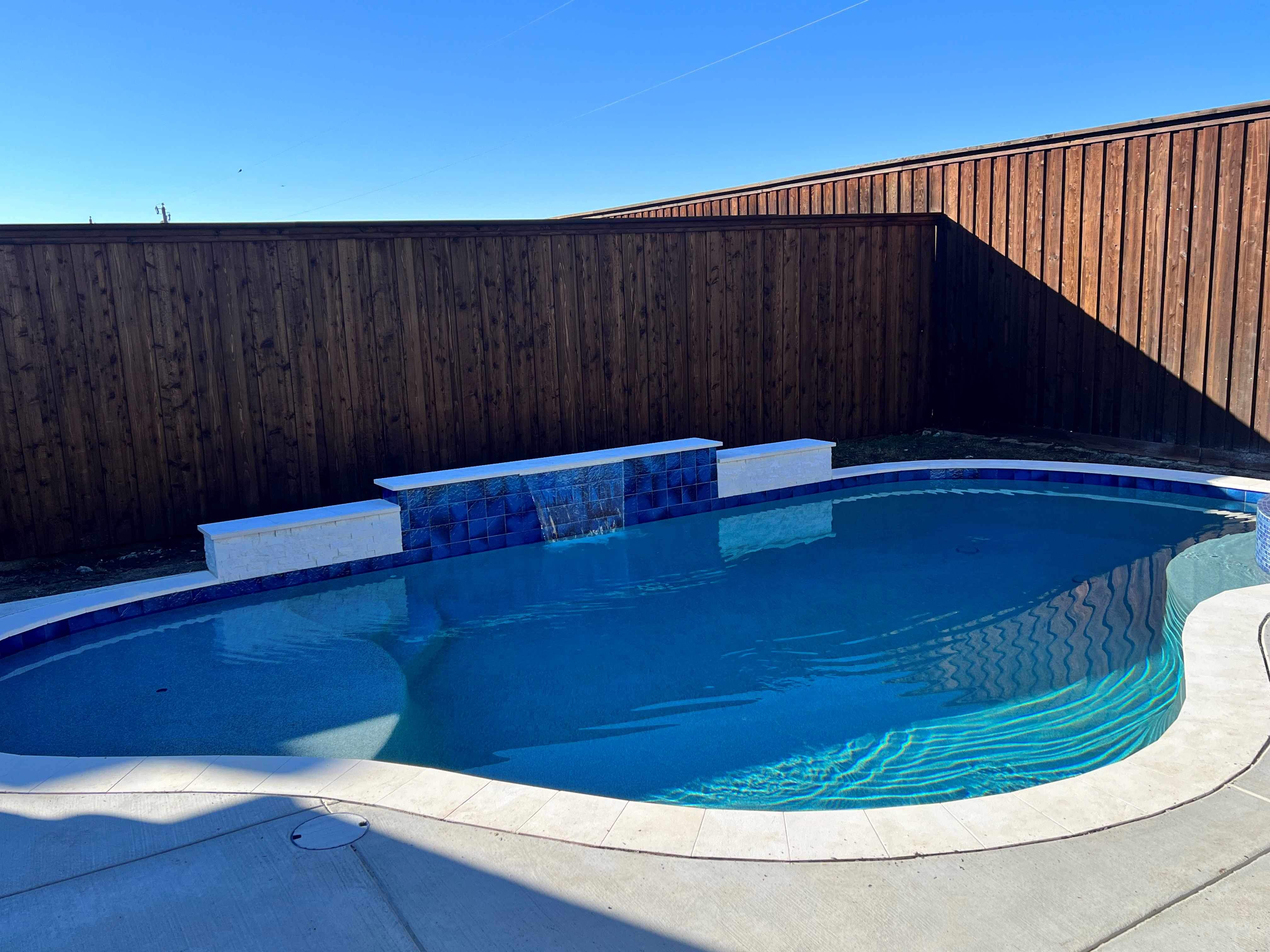 Freeform Pool with Rock Waterfall and Raised Spa by Pinnacle Pools and Spas - DFW