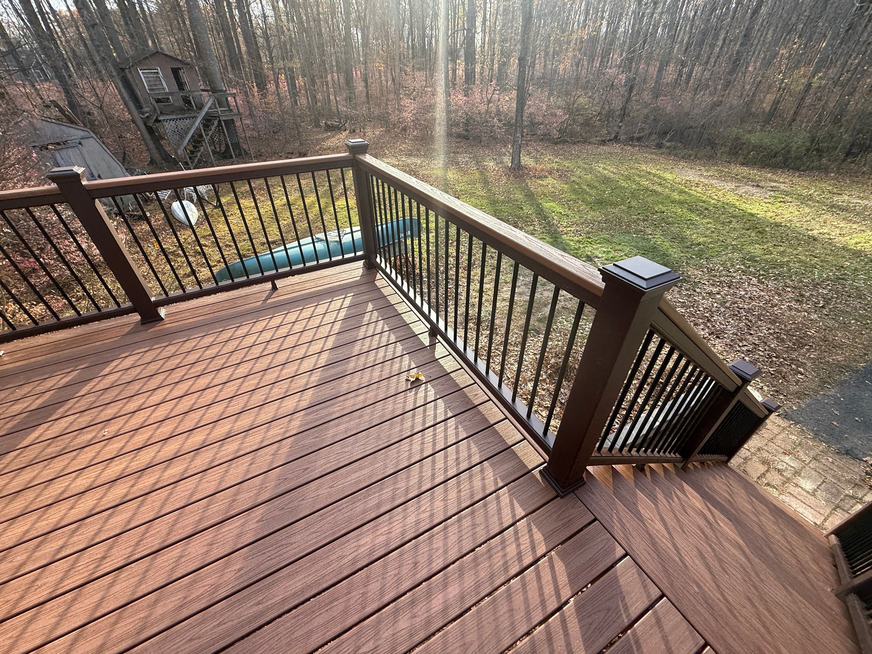 Replacement deck with Trex Tropical Tiki torch and Transcend Cocktail railings in vintage lantern. by DiGiorgi Roofing and Siding Inc