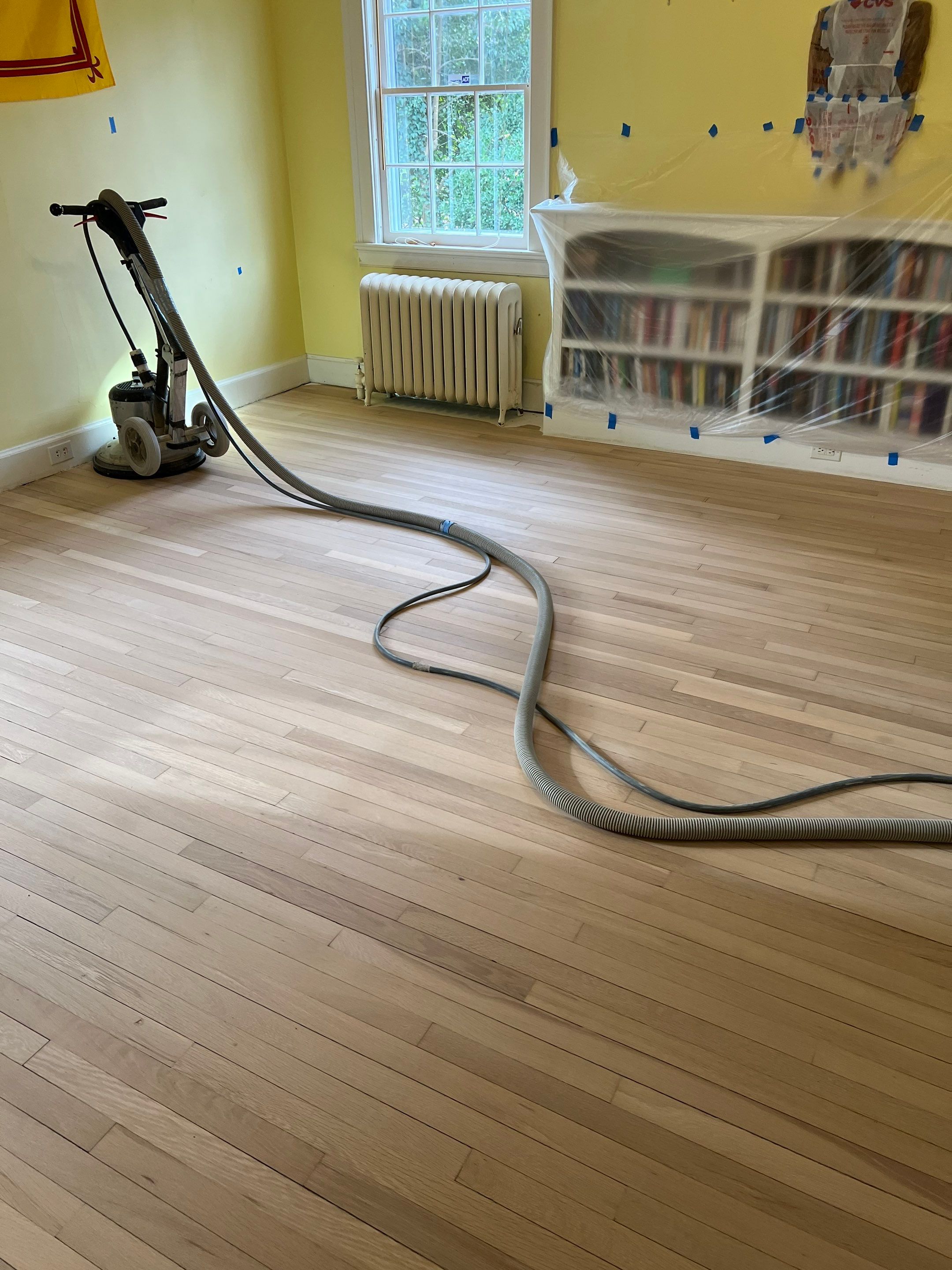 Two bedrooms with hardwood under carpet by Accent Custom Floors