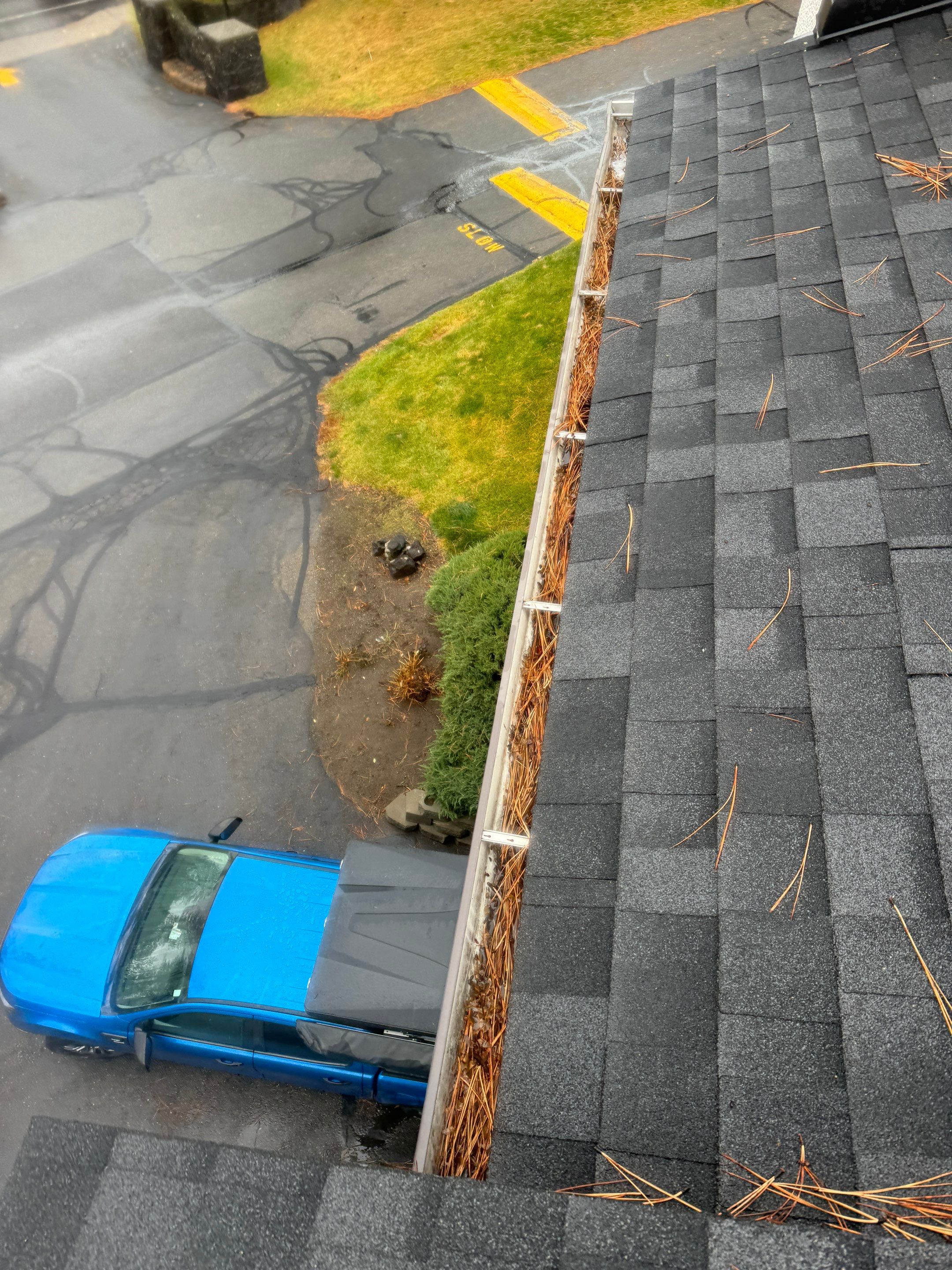 Commercial gutter cleaning Spokane before photo with filled gutters