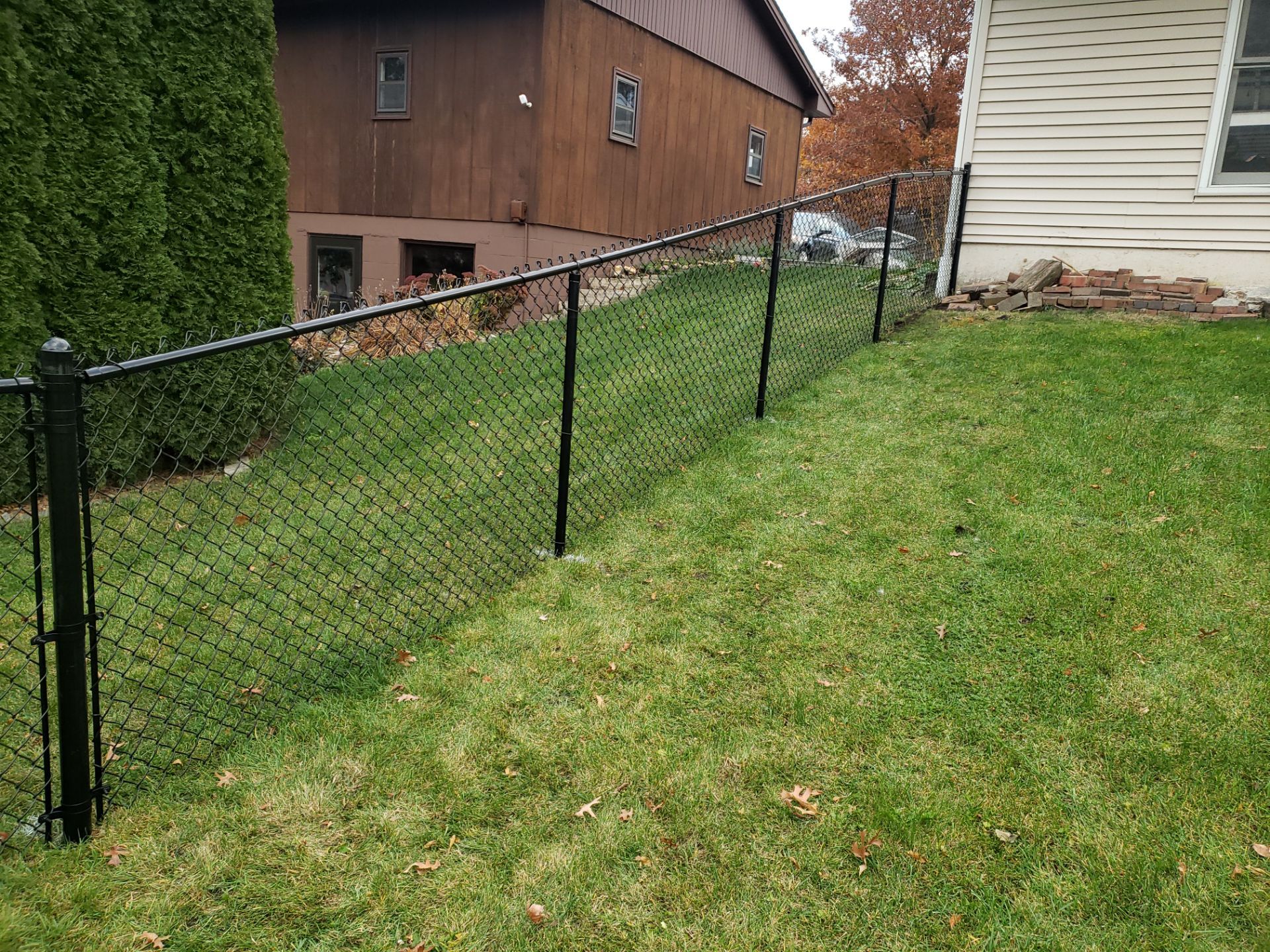 Residential Black Vinyl-Coated Chain Link Fence in Grundy Center by Perfect Picket Fence and Stain