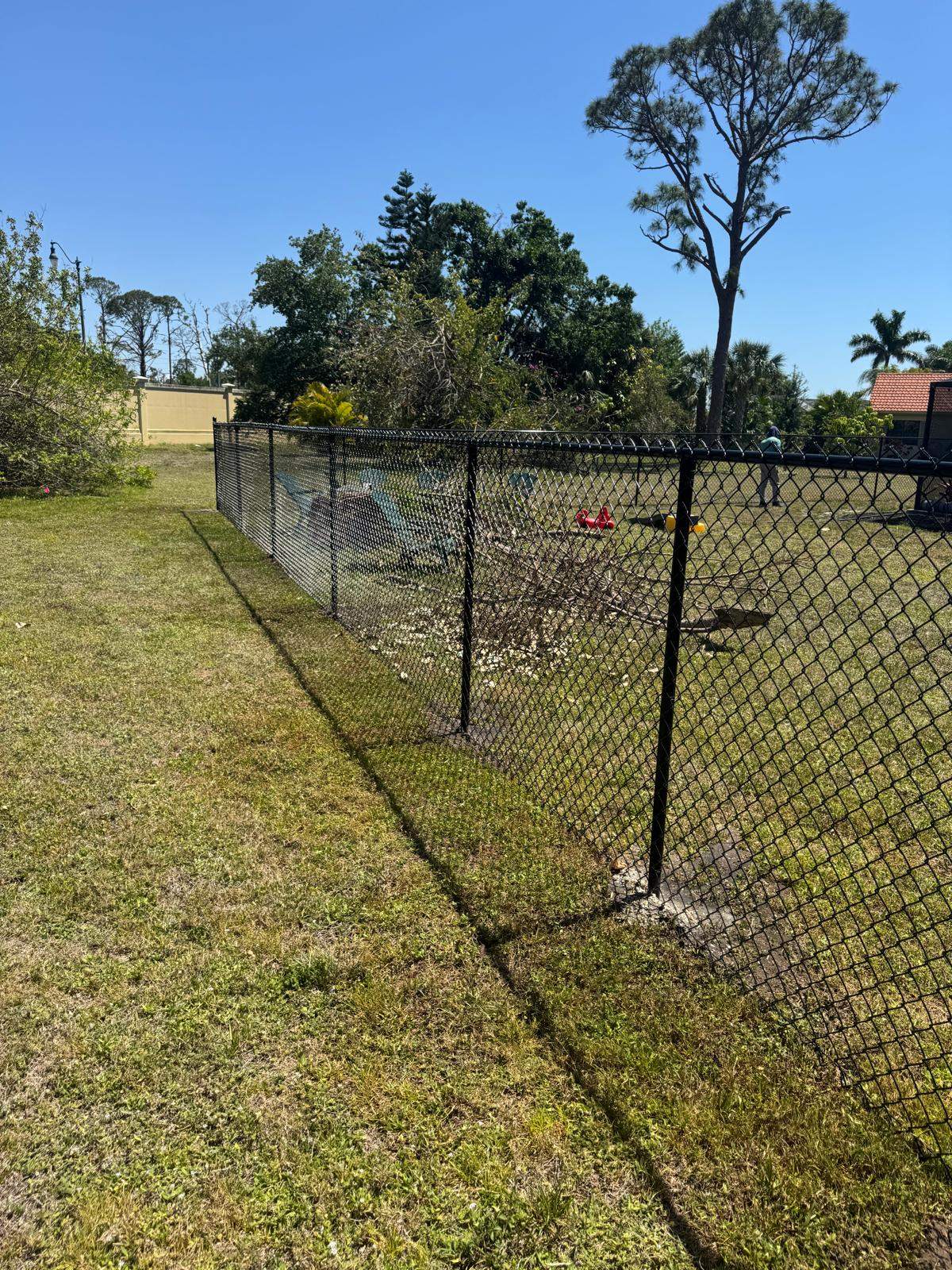 Black Chain Link Residential Backyard Fence Installation in North Port by True Fence LLC