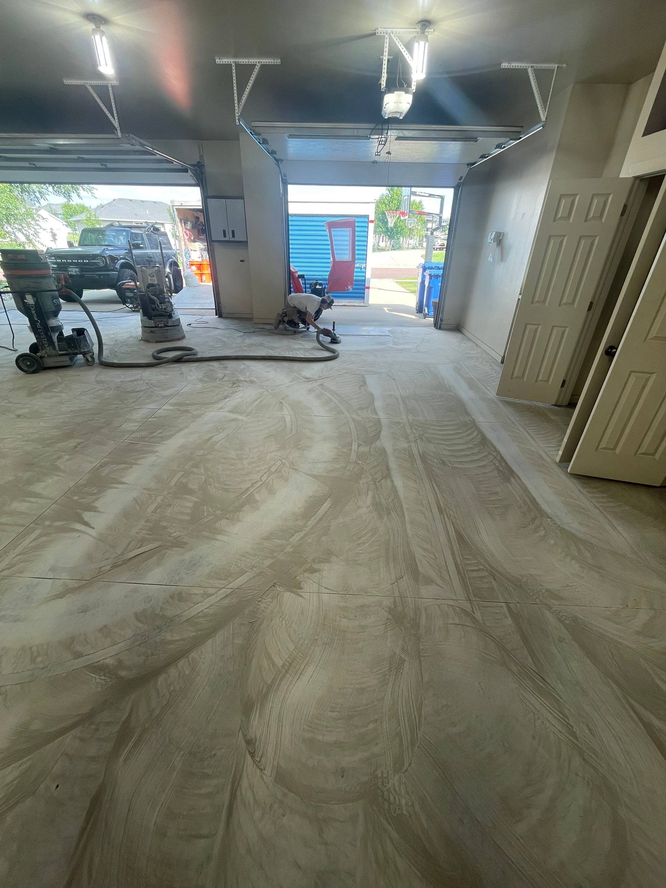 Coyote Flake Garage Floor Coating in Sioux Falls with Trench Drain by Select Painting, Coatings & Garage Cabinets