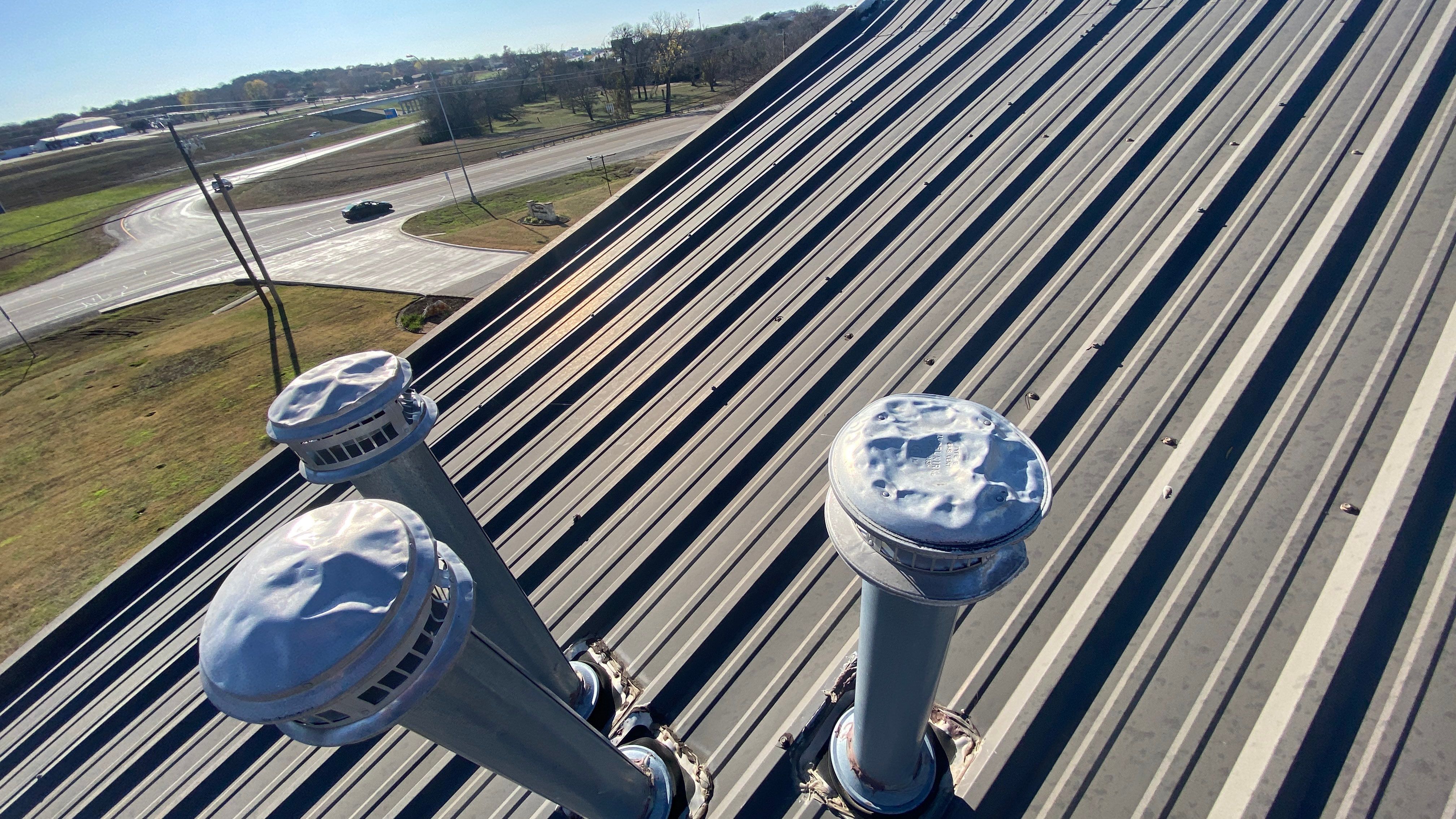 Commercial Roofing Installation using 24 GA 2" Seam Metal Retrofin - Buckskin by Action Exteriors Austin