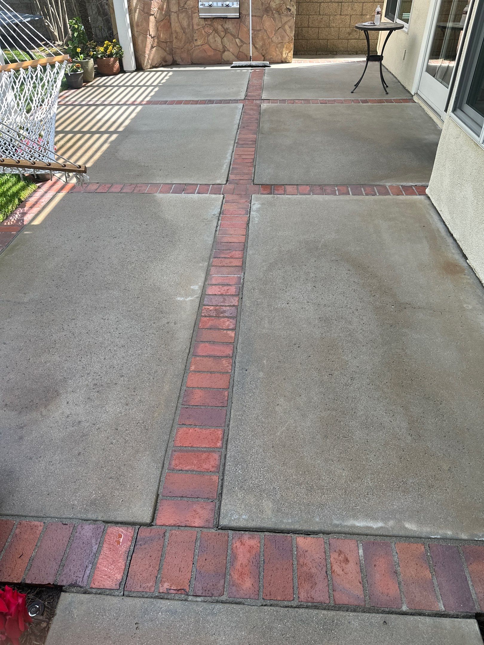 Surface cleaning pressure washing in Orange County on patio, walkways, and driveway by Property Cleaning Experts, LLC