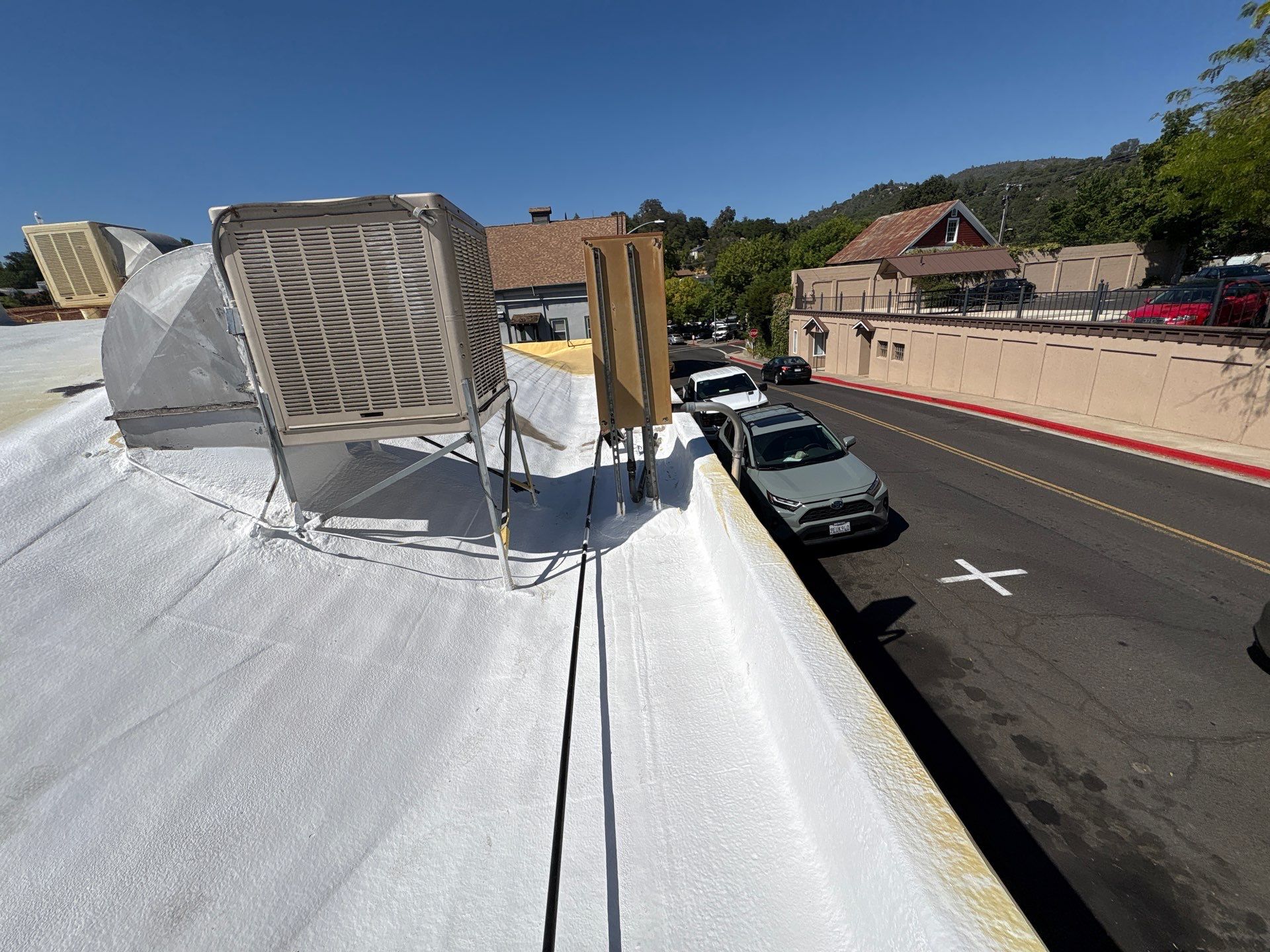 Foam and coatings on commercial roof by Straight Edge Roofing Inc