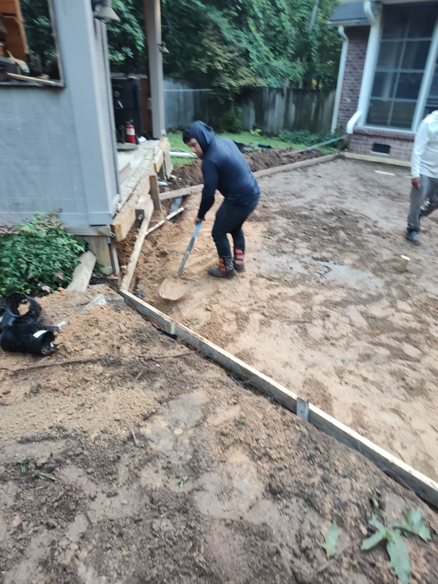 Patio in concrete with drainage improvements by Cornerstone Home Builders, LLC