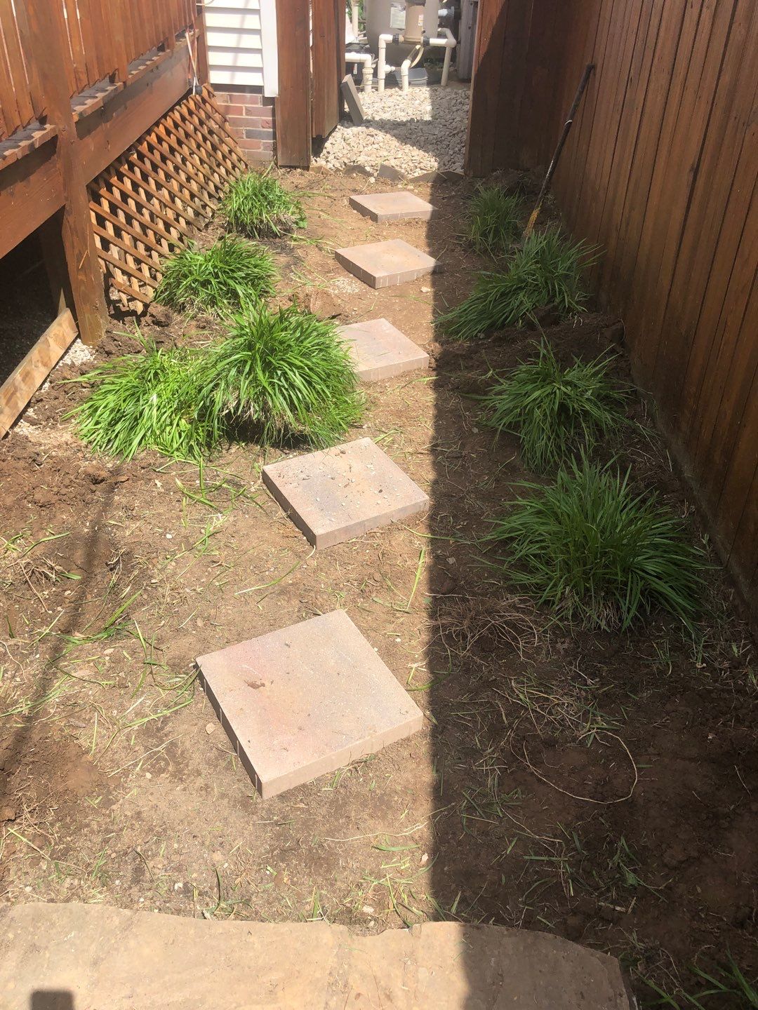 Liriope grasses, mulch and stone pavers by GrassBusters, Inc.
