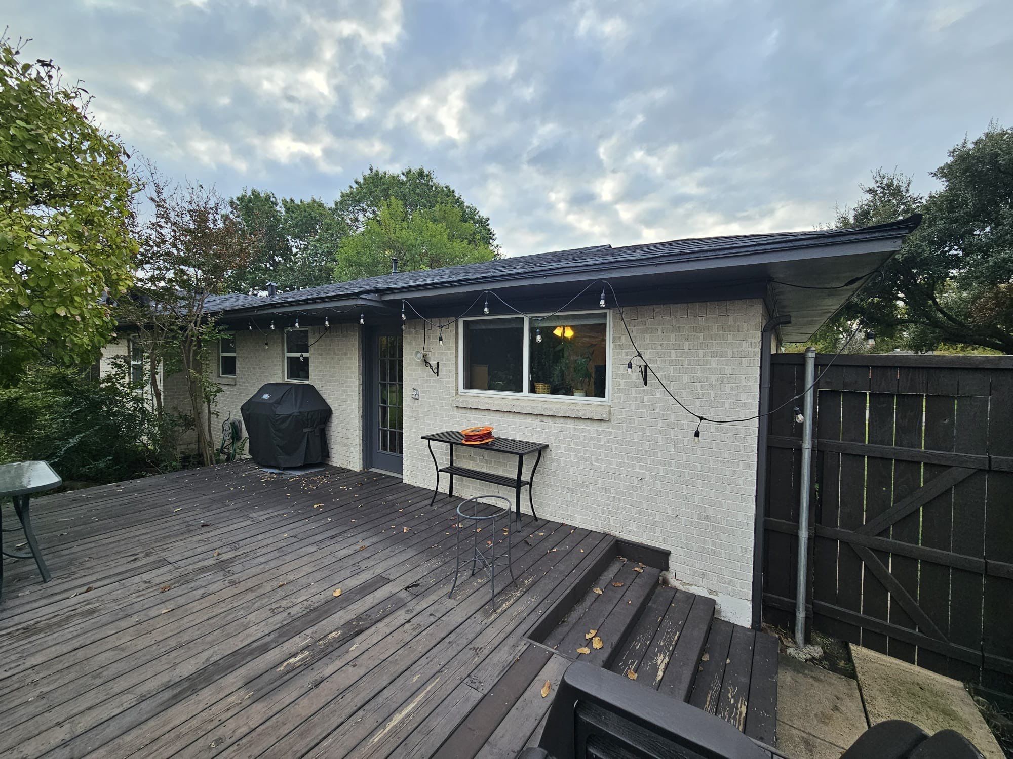 White brick/black accents with IKO Granite Black by Tejas Roofworks + Restoration
