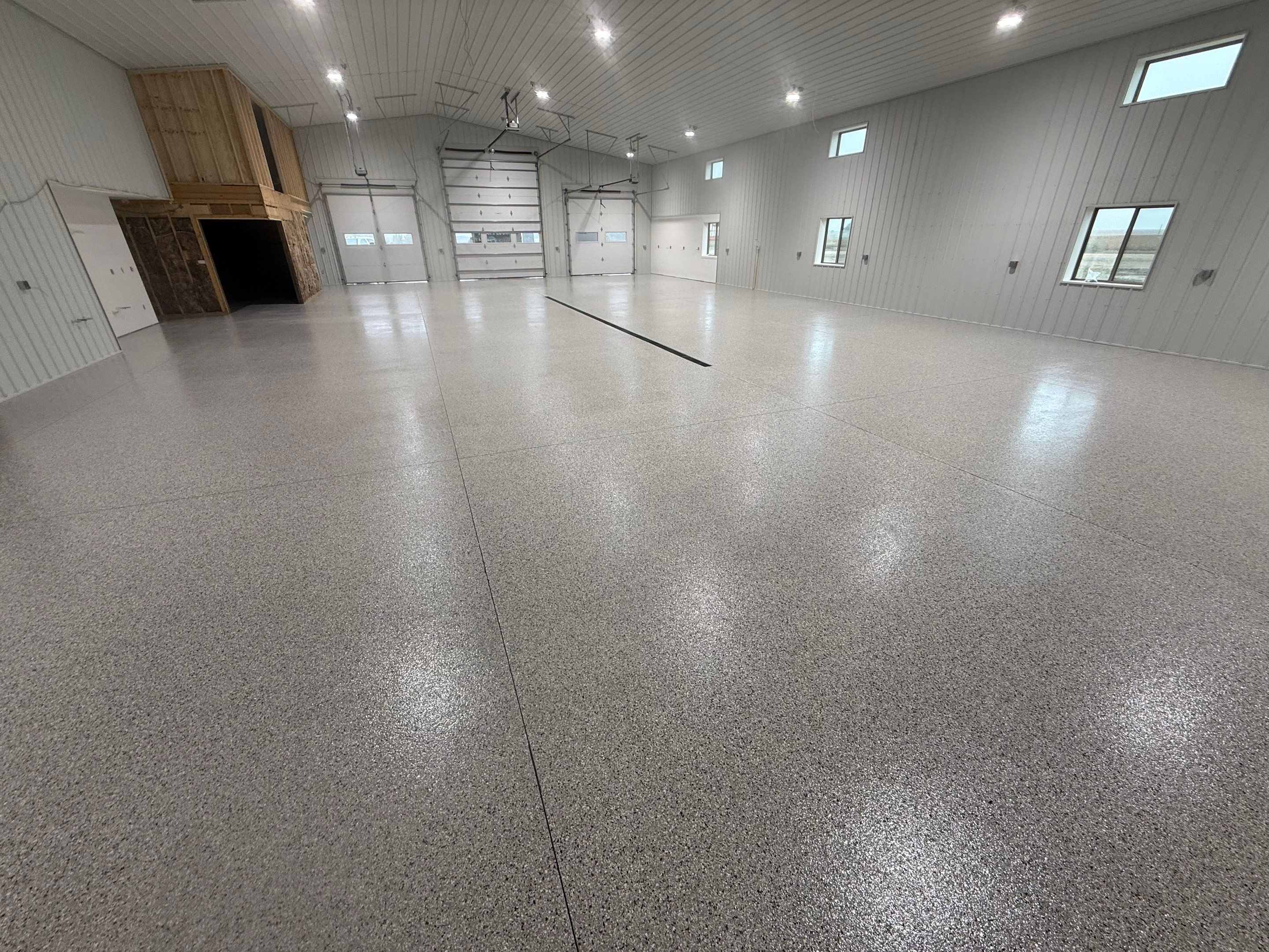 Custom Speckled Floor Coating for Large Montrose Shop by Select Painting, Coatings & Garage Cabinets