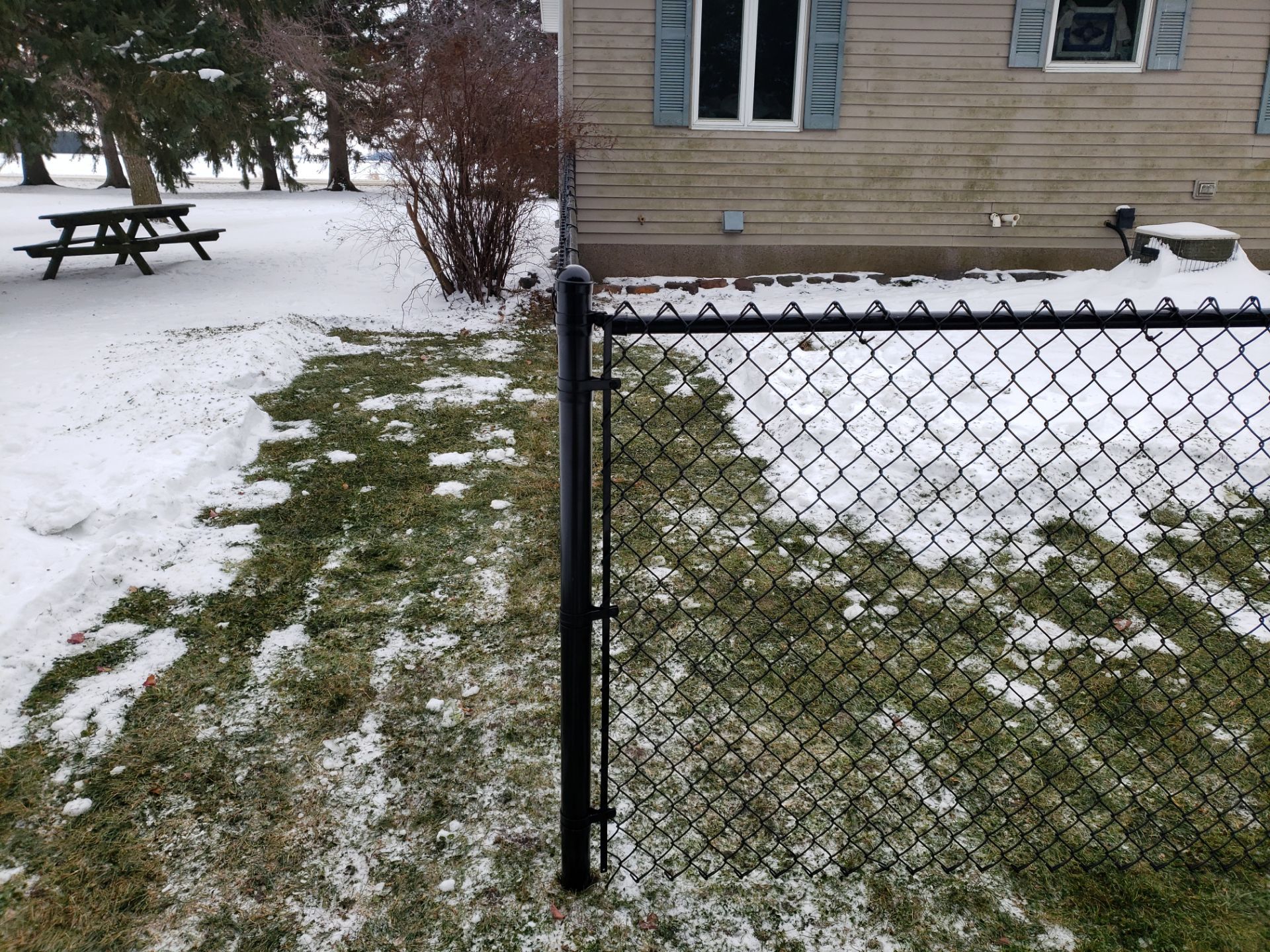 Black Vinyl-Coated Chain Link Fence Installation in Oelwein by Perfect Picket Fence and Stain