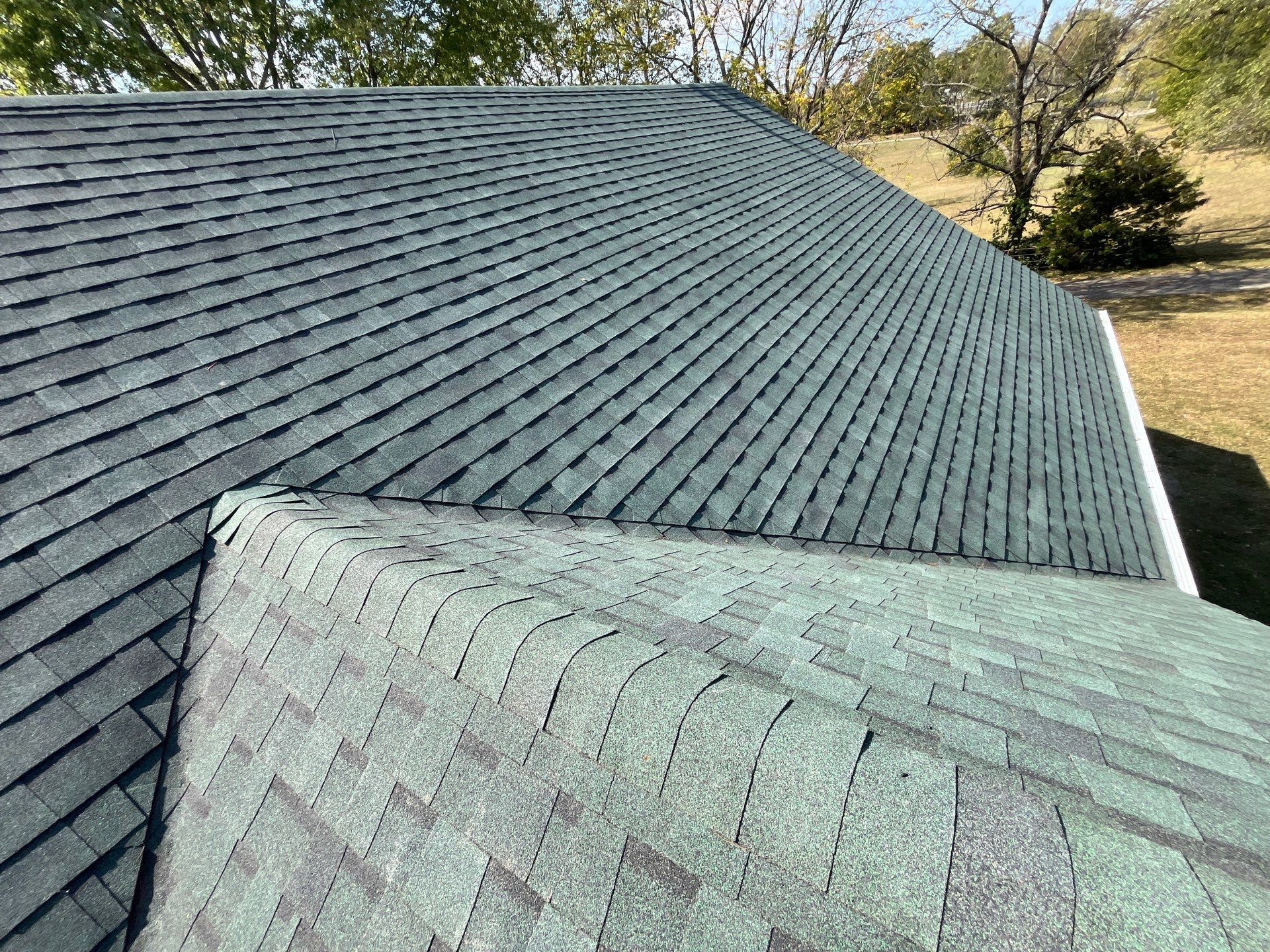 Residential Roofing Install - Green Atlas Pinnacle Pristine Shingles - White Gutters & Downspouts  by Titan Commercial & Residential Roofing 