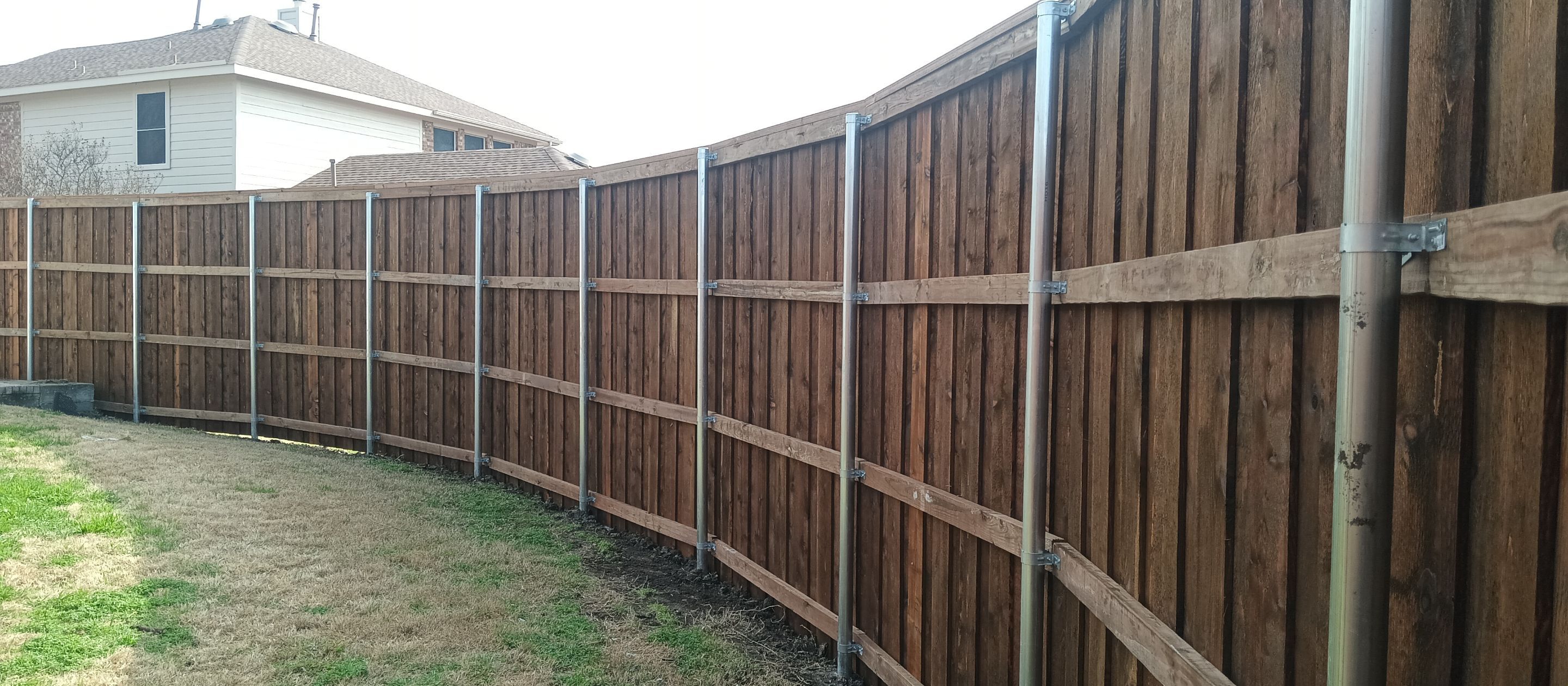 Pre-Stained 8' Board on Board cedar w/ trim and cap  by Grizzly Fence And Patio