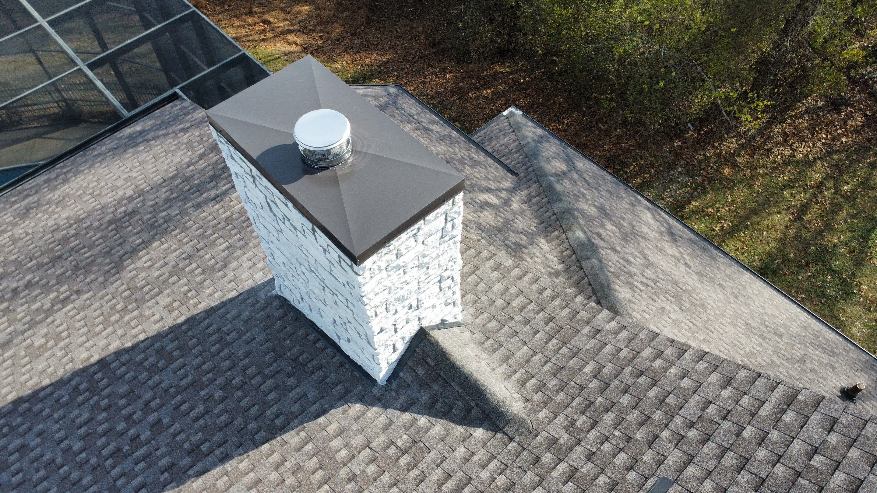 Roof and Gutter System Replacement with Stone Chimney Rebuild by Undersun Roofing 