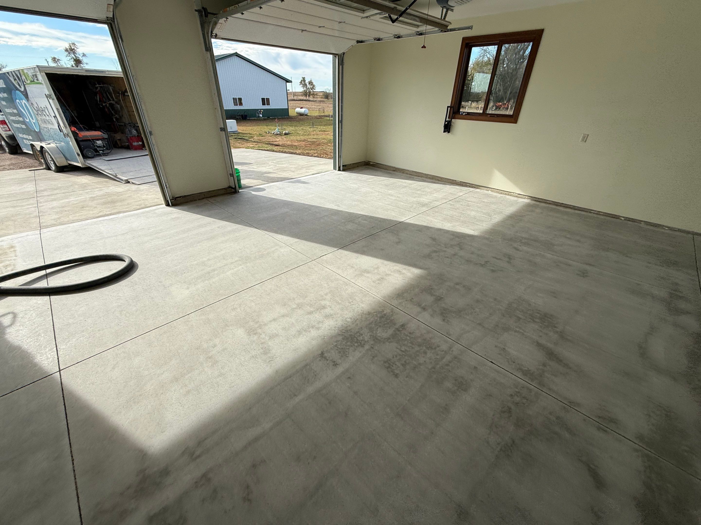 Speckled Epoxy Garage Floor Coating and Concrete Repair in Lennox by Select Painting, Coatings & Garage Cabinets