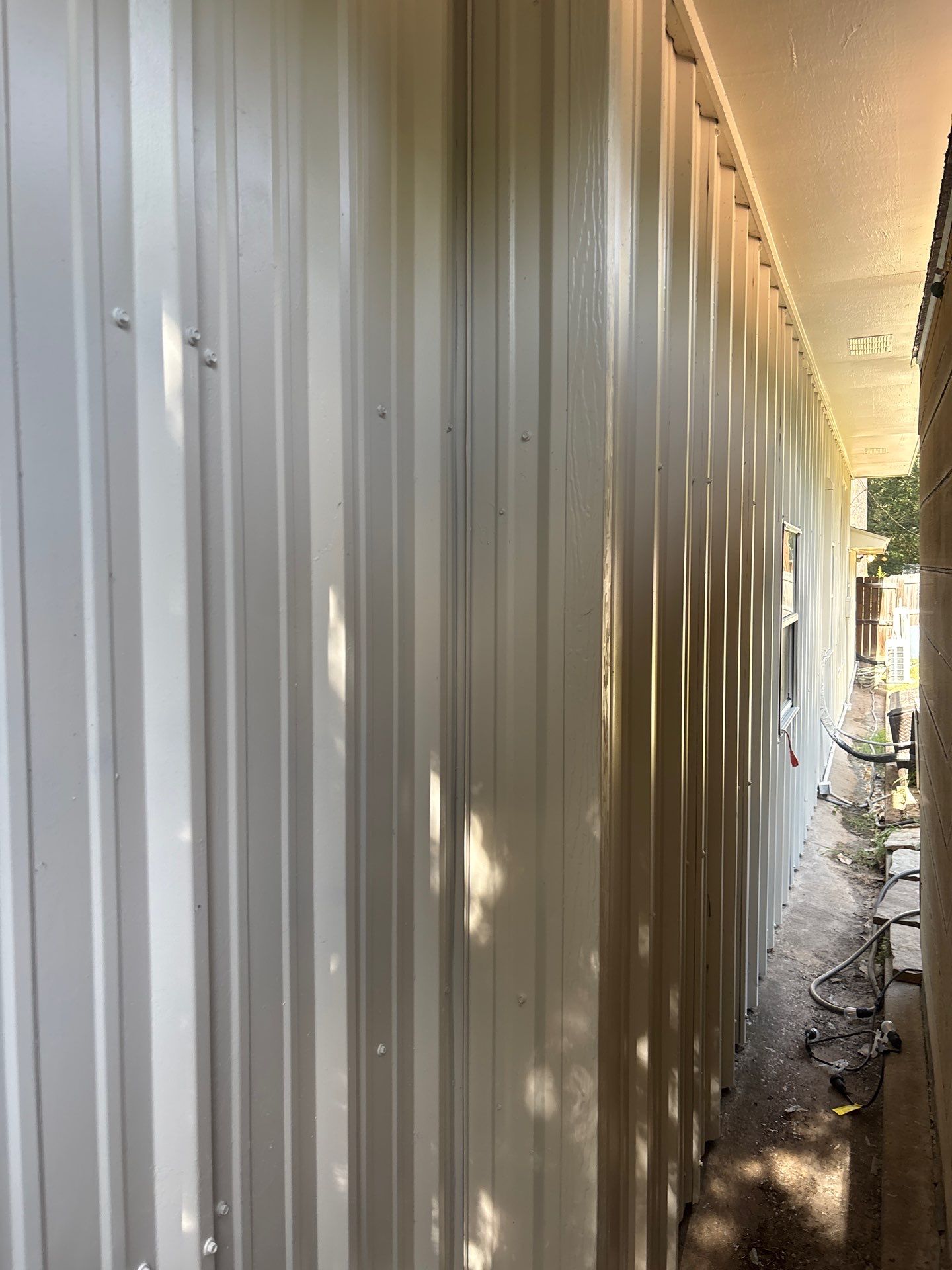 Exterior Painting in Flint, TX | White Brick Home & Metal Building with Sherwin-Williams Duration by Quality Coats Painting