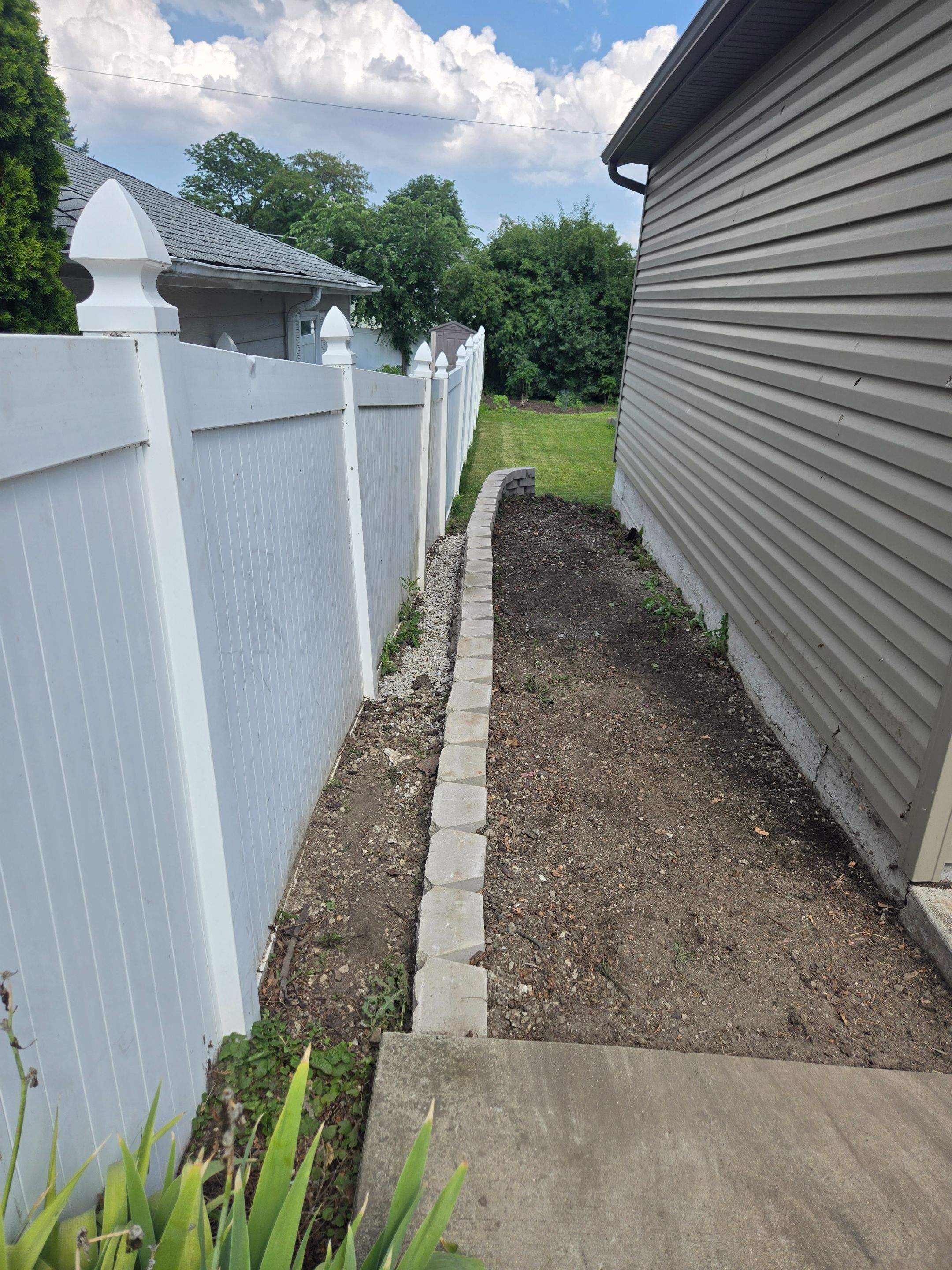 Split faced landscape block retaining wall and French Drain Installation by Allied Water Services