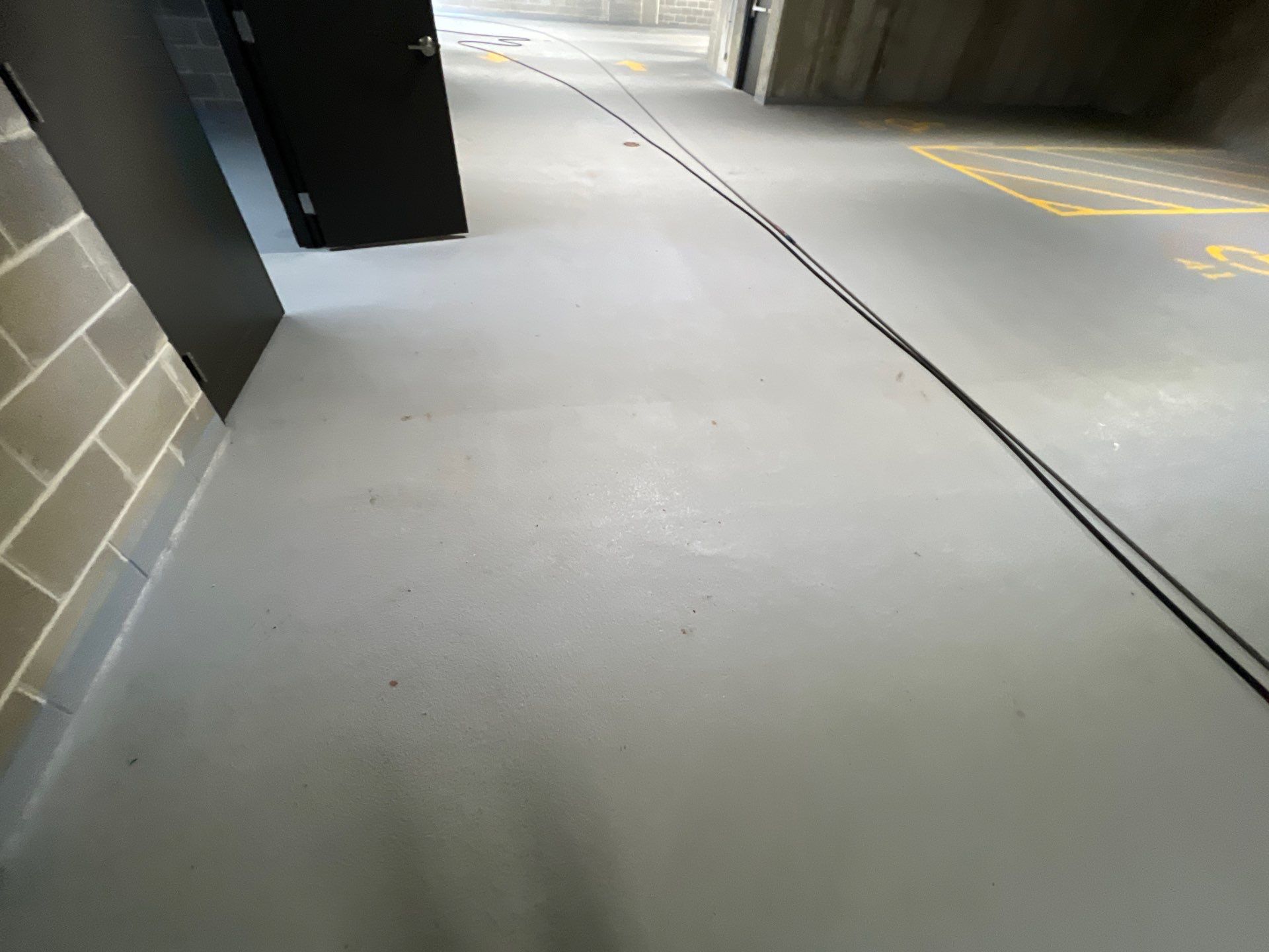 Parking garage using Hot water by Northern Power Washing LLC.