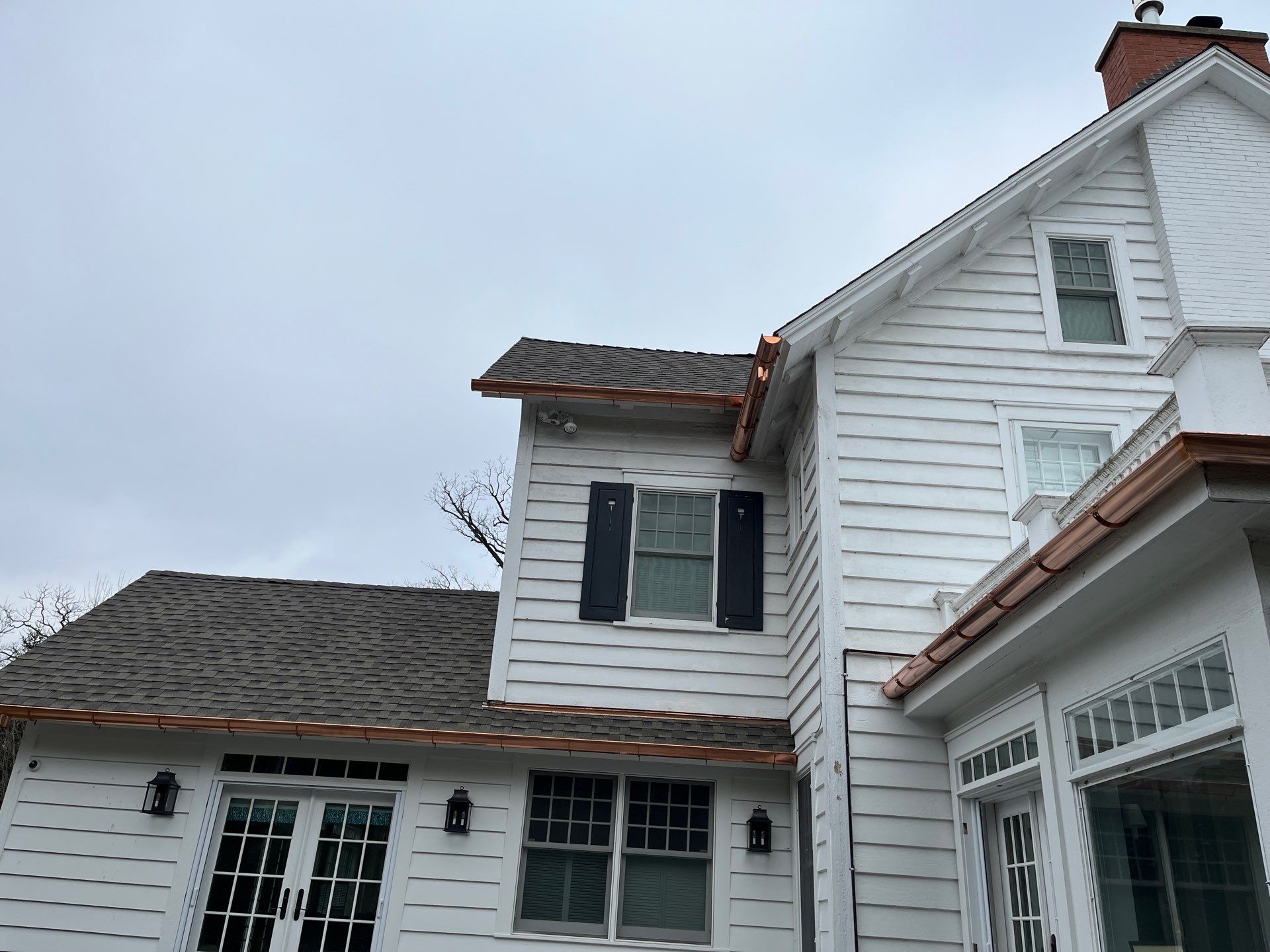 Asphalt Roof Replacement with Half Round Copper Gutter Installment by Custom Installations