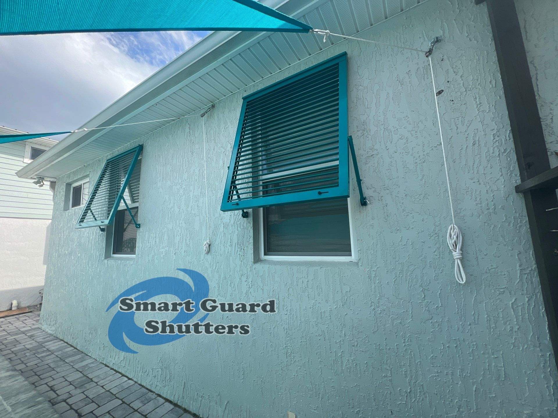 Impact Bahama Shutters in Water Blue by Smart Guard Shutters