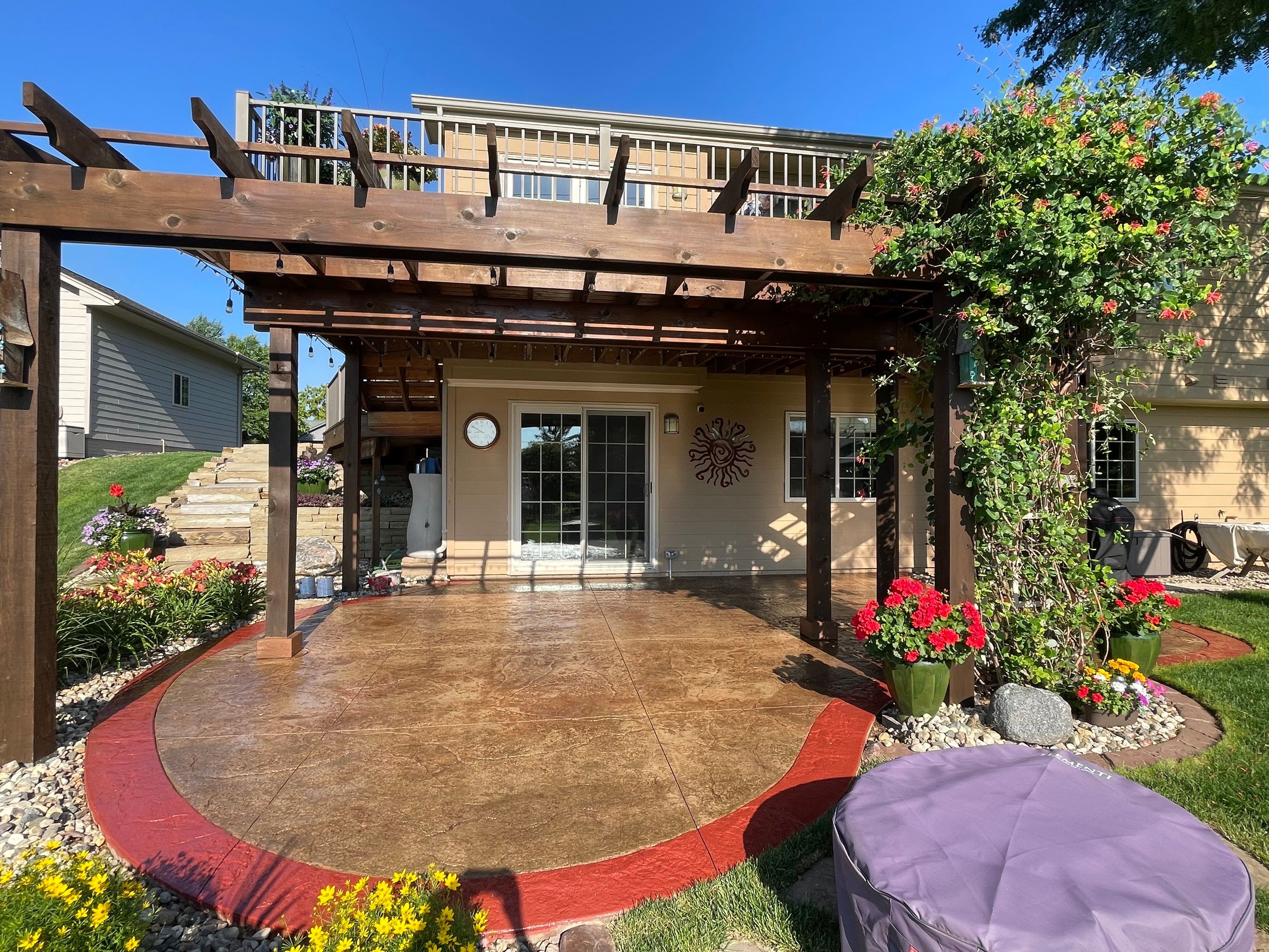 Custom Stamped Concrete Patio and Wood Pergola in Sioux Falls by Select Painting, Coatings & Garage Cabinets