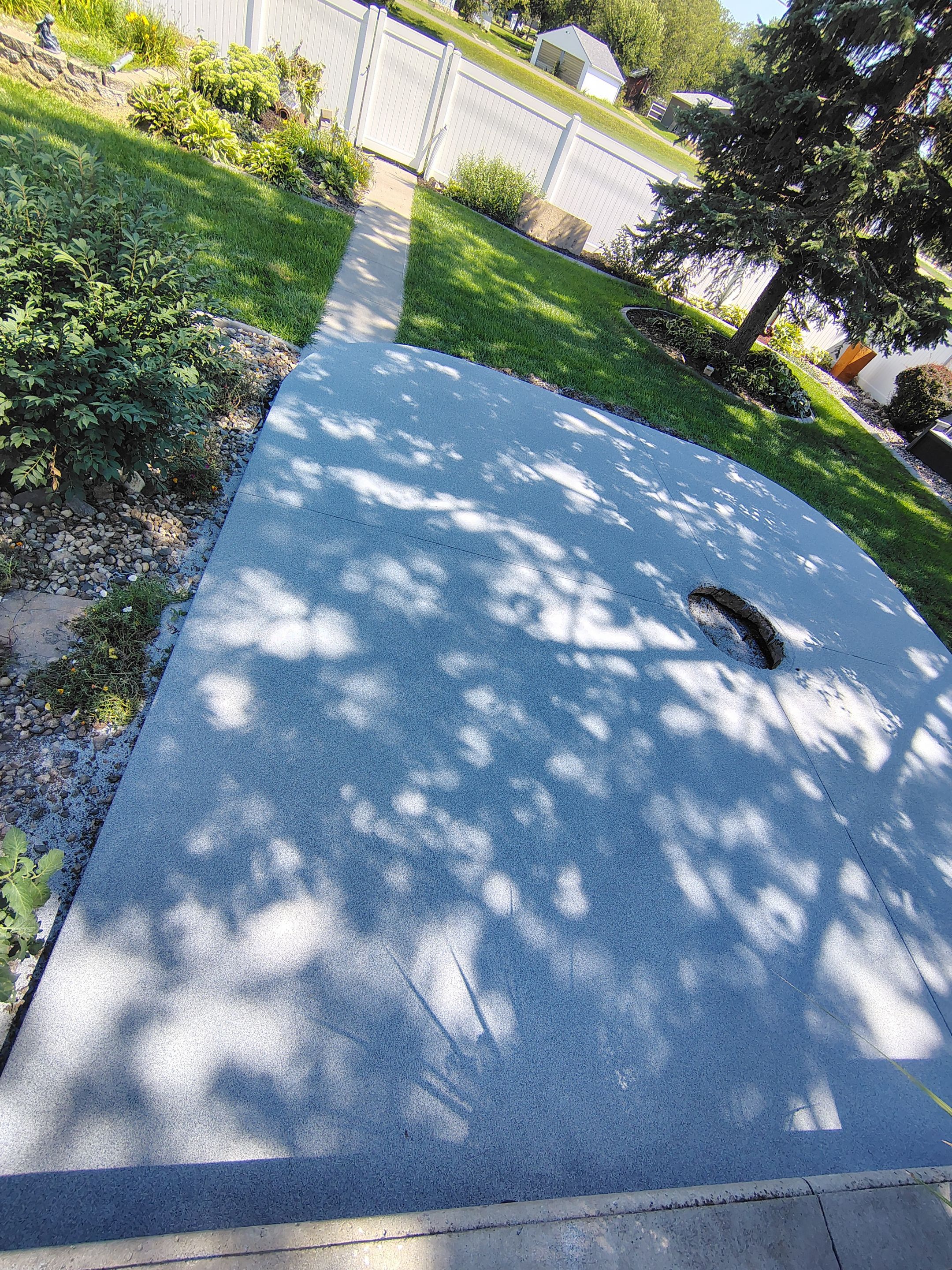Custom Garage Floor Coating and Backyard Patio Refinishing in Tyndall by Select Painting, Coatings & Garage Cabinets