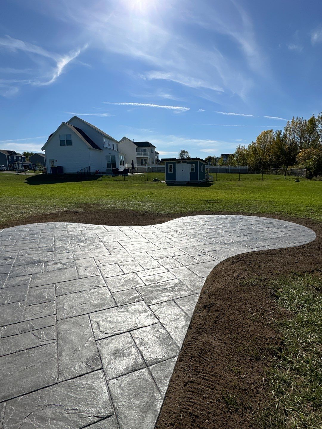 Majestic Ashlar stamped concrete patio with rock face steps  by NG Masonry & Construction LLC