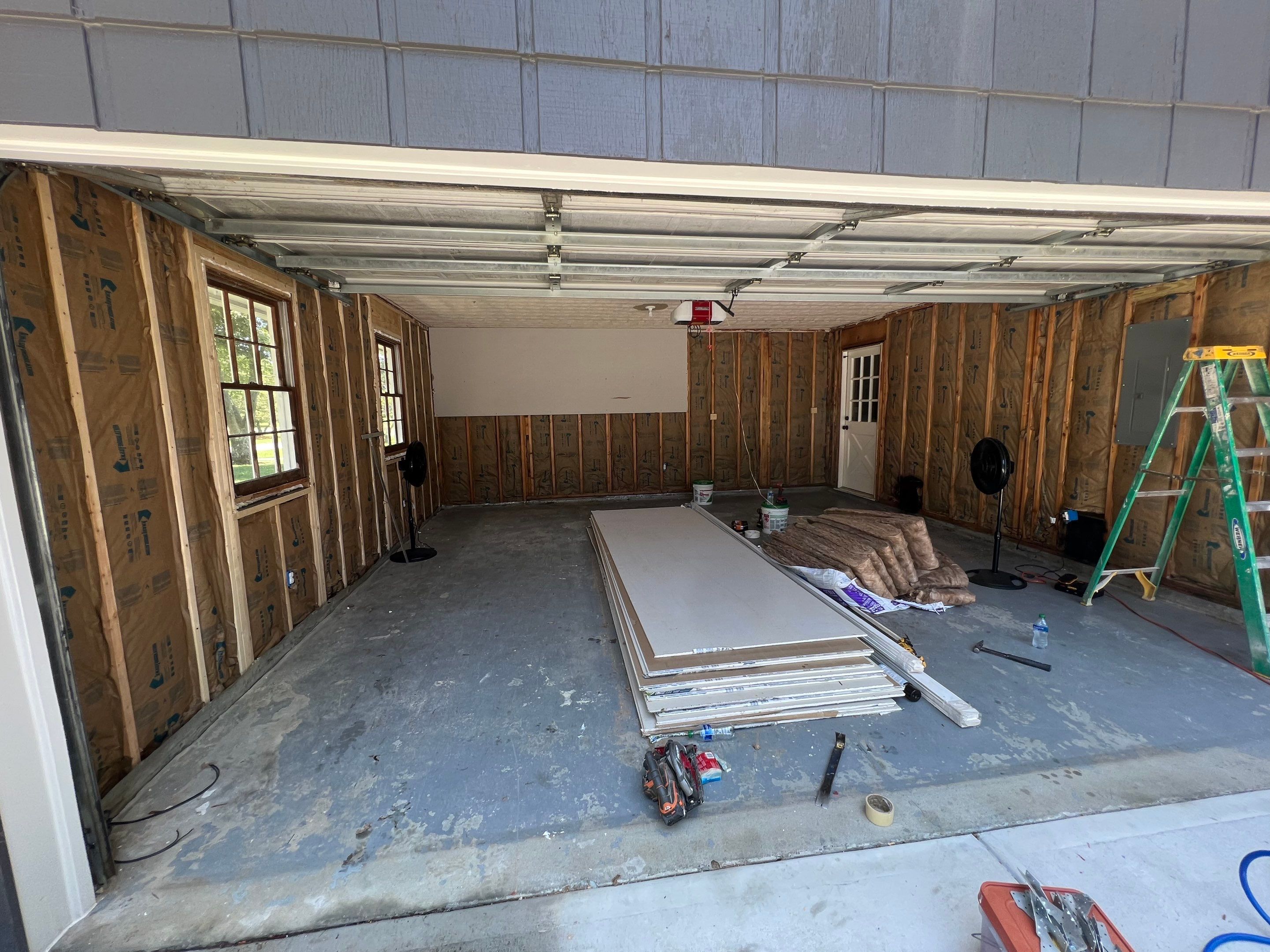Snellville Garage Remodel Featuring Epoxy Floors and Board and Batten Siding by Swift Home Renovations