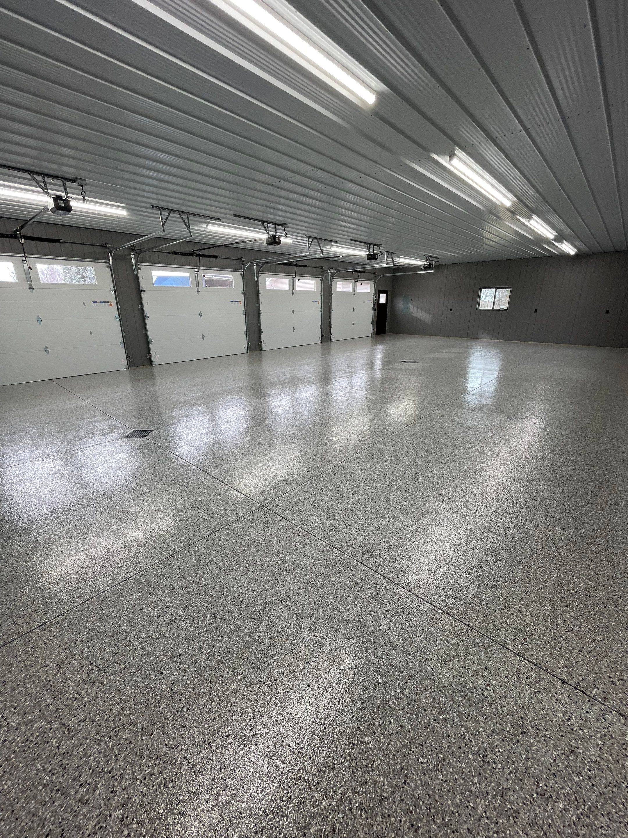 Speckled Epoxy Floor Coating for Large Shop in Rock Valley by Select Painting, Coatings & Garage Cabinets